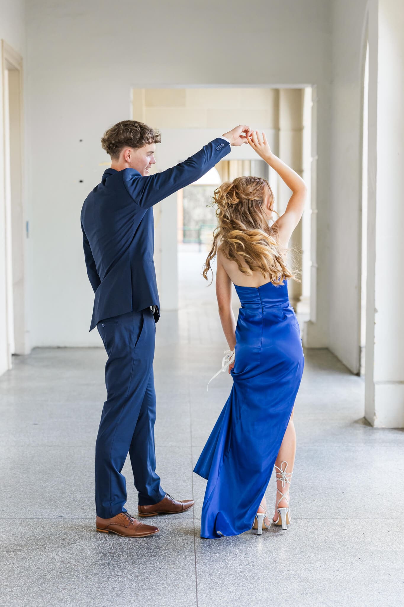 Formal Dress Rockhampton worn by high school graduate while being spun around by her partner.