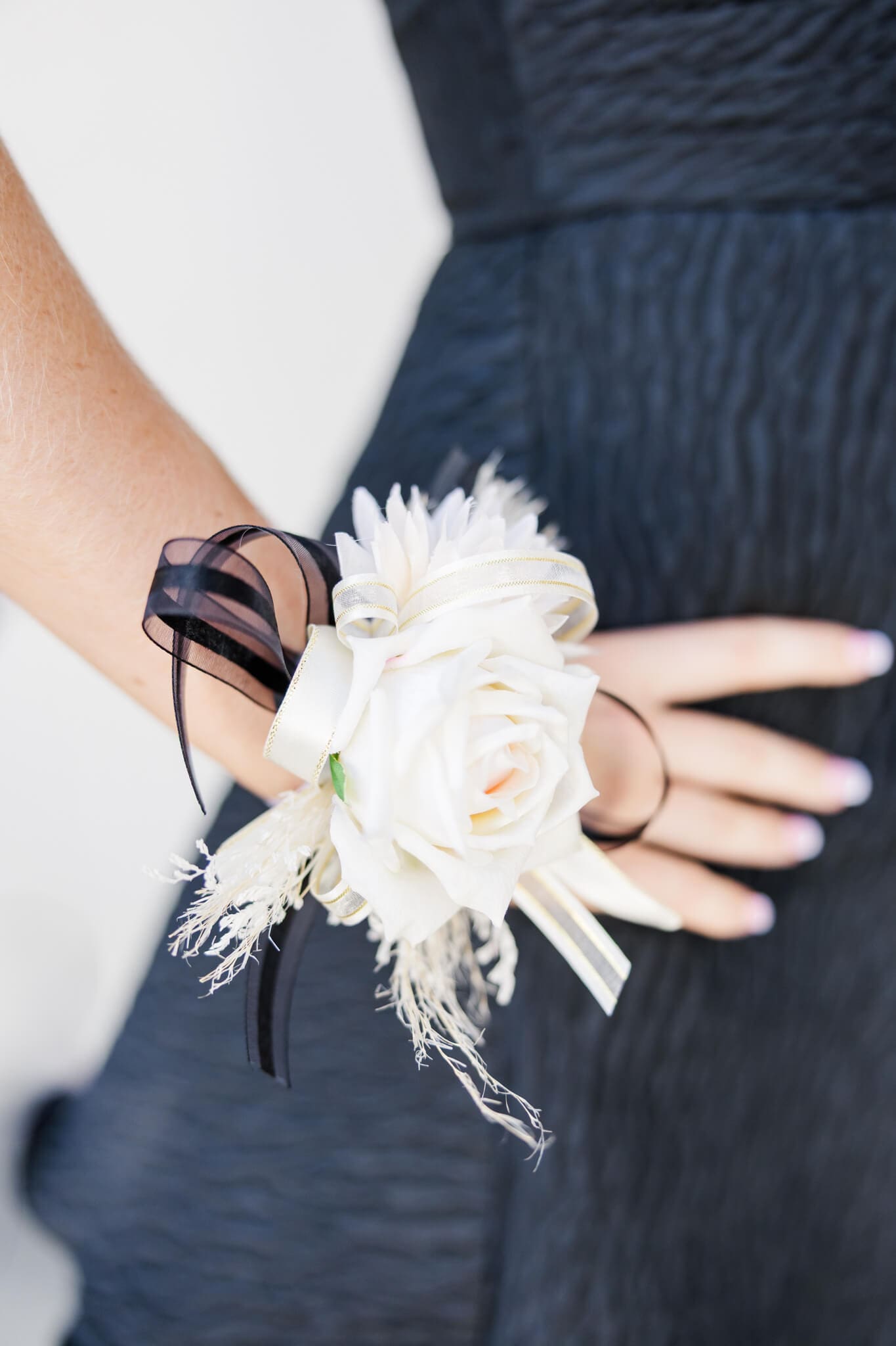 Corsage on the arm of a graduate on her formal day.