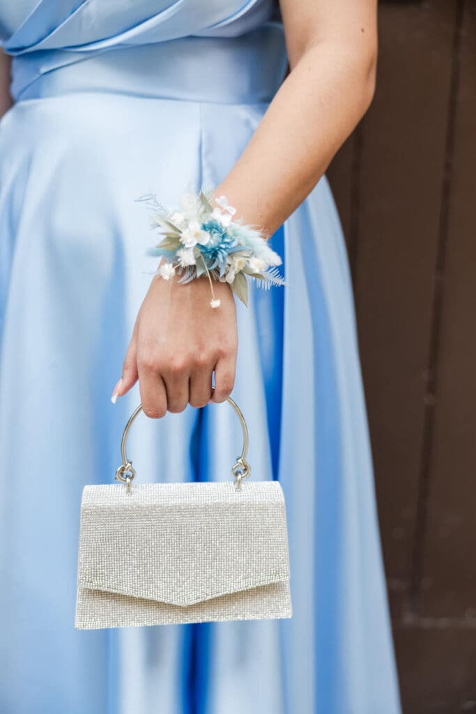 Detail photo of a corsage, on an arm of a high school senior girl on formal day.