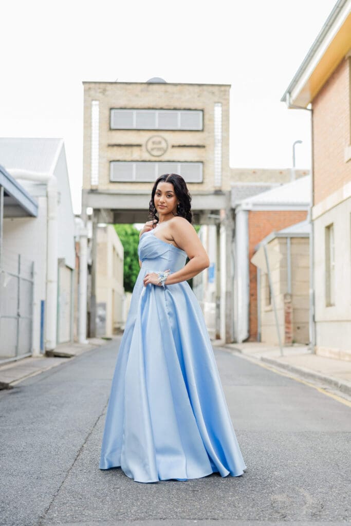 Beautiful photo of a girl dressed in a sky blue formal dress by Runway 7 Boutique. Photographed by Julie-Anne Photography.