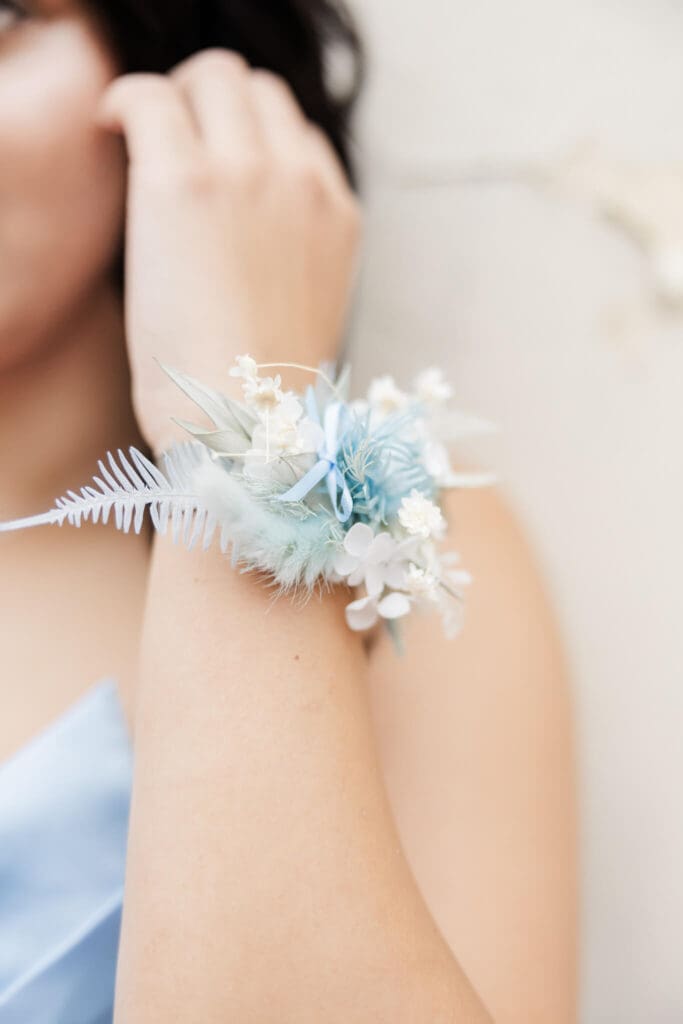Detail photo of a corsage, on an arm of a high school senior girl on formal day.