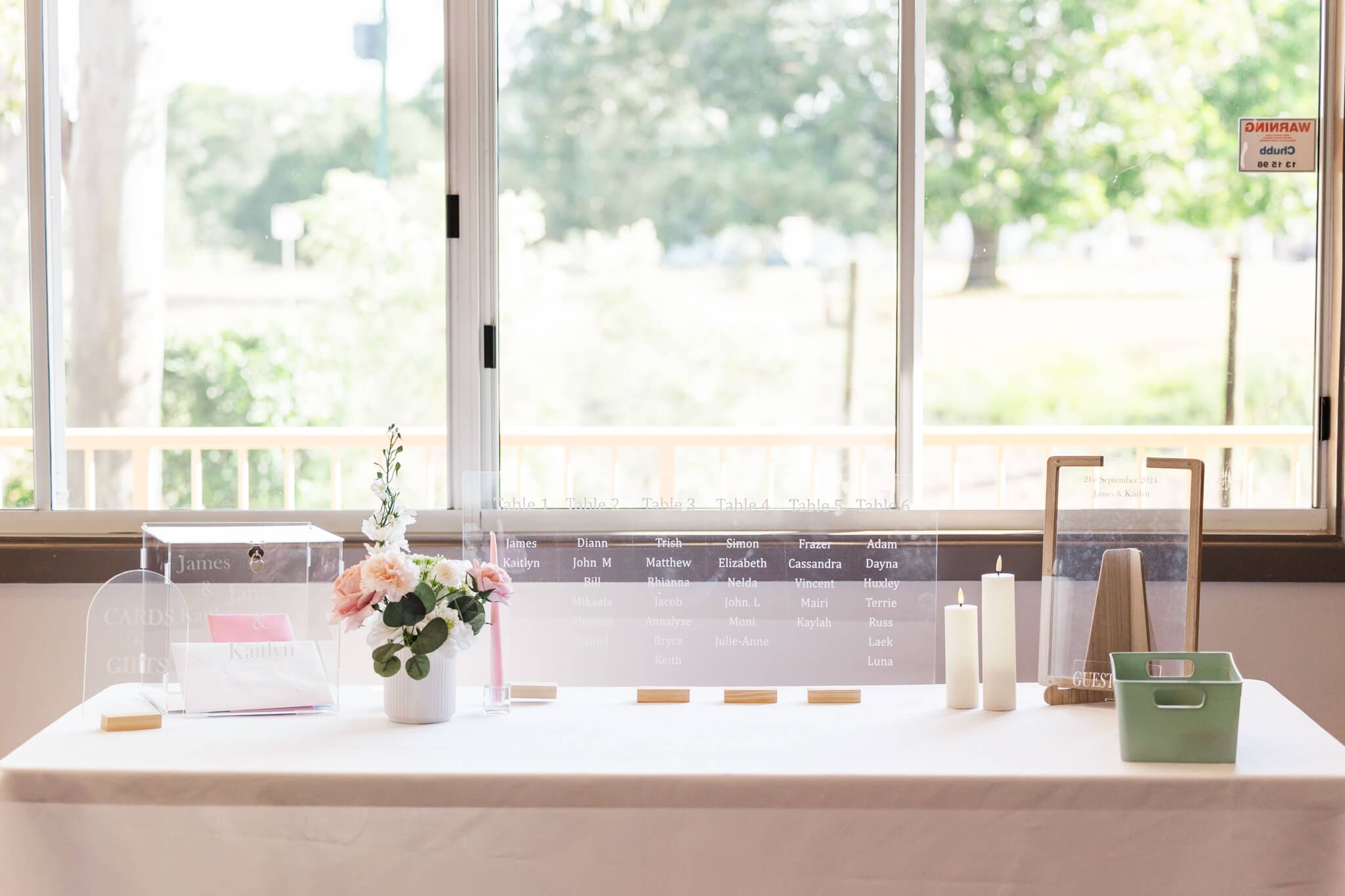 Seating arrangements printed on a clear acrylic board for a wedding reception, and styled in wedding colours. Captured by Julie-Anne Photography.