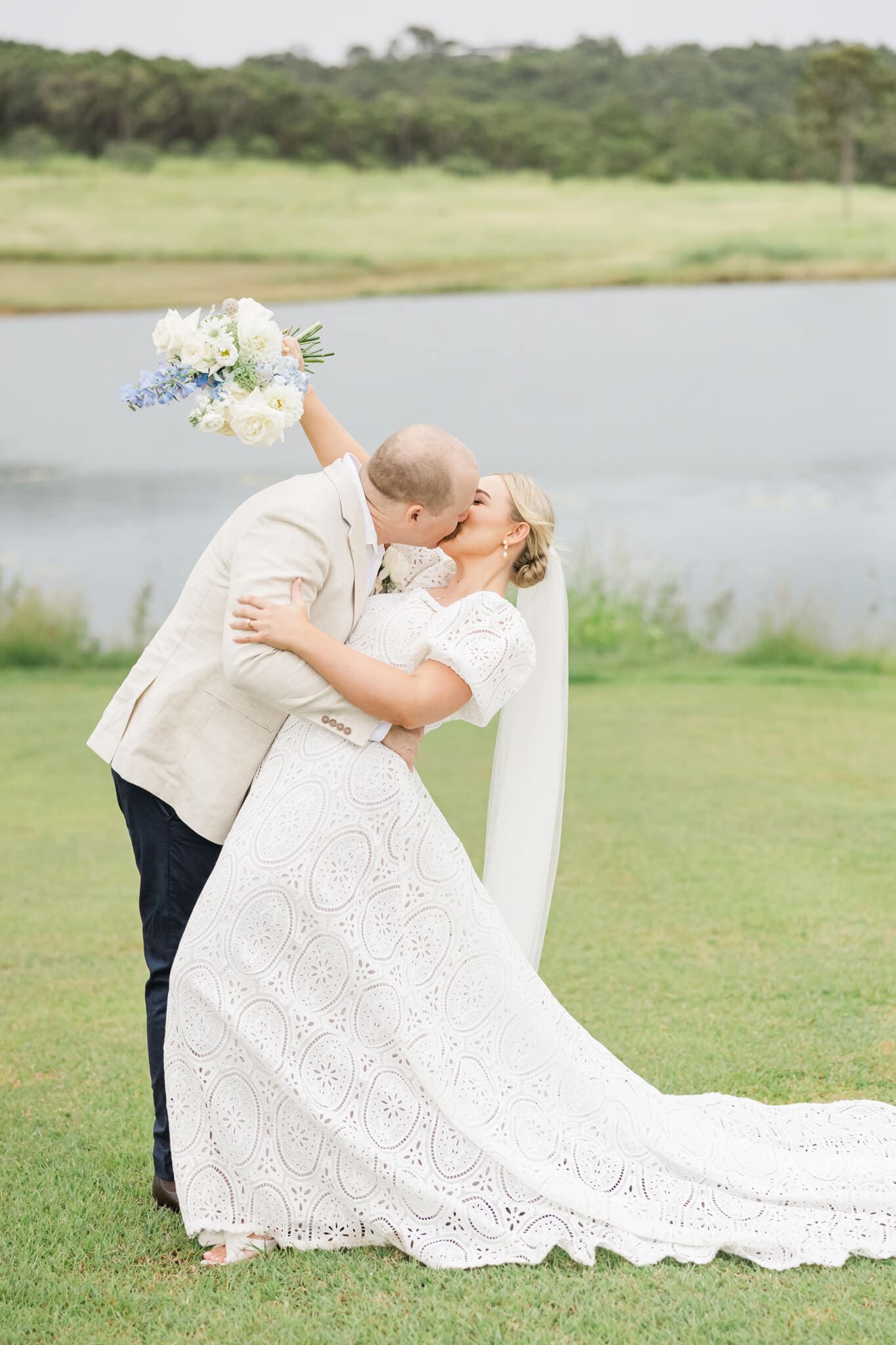 Groom dipping the bride back to give her a kiss. Taken at a Yeppoon Wedding Venue