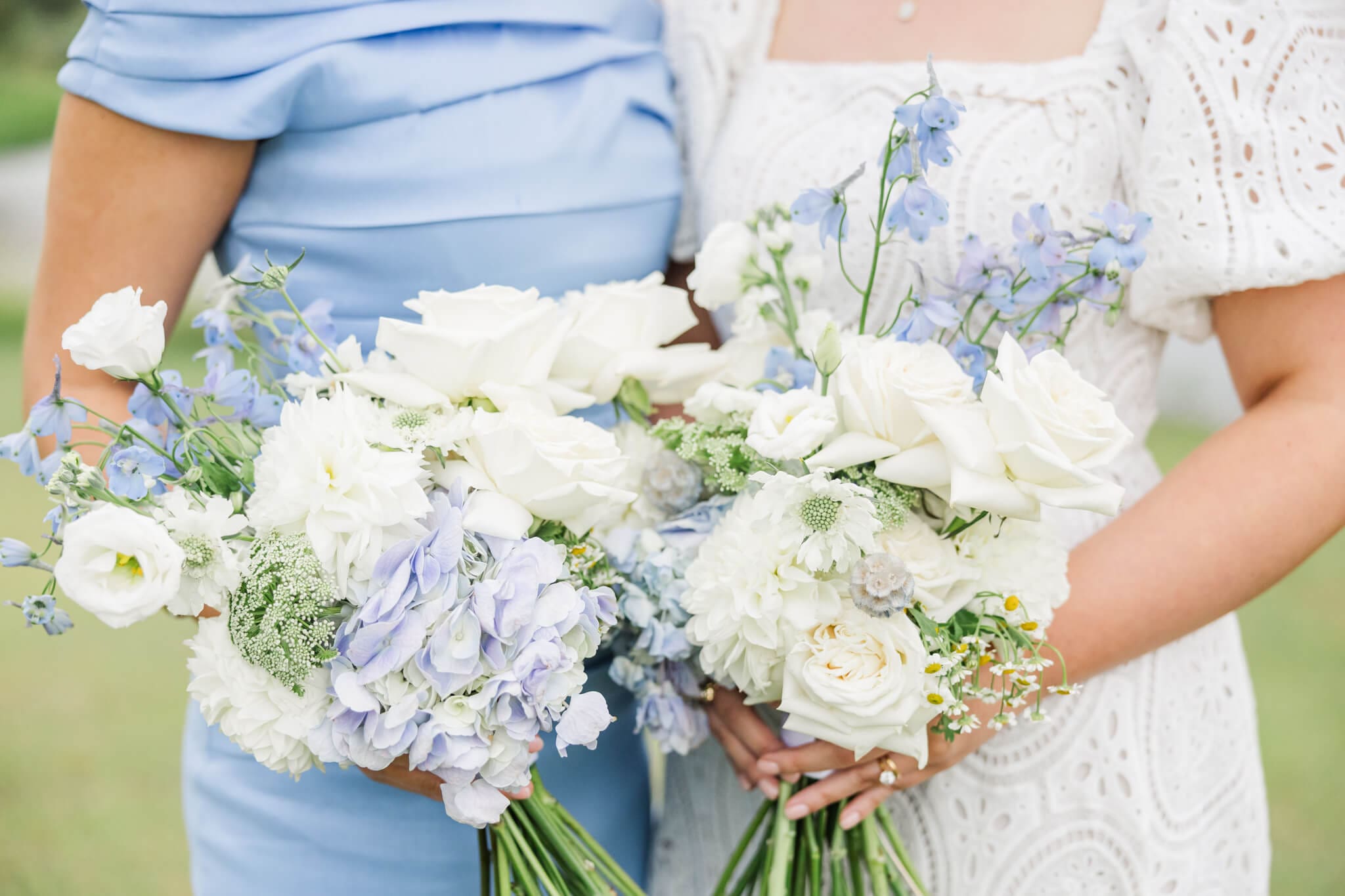 Detail Shot of a  bride and bridesmaids bouquet consisting of blue, cream and white florals.