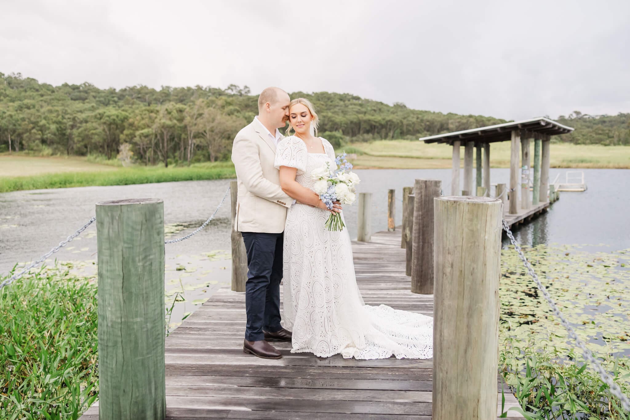 Bride and Groom pose in the jetty at the Salty Lime Co. Wedding venue near Yeppoon, Queensland