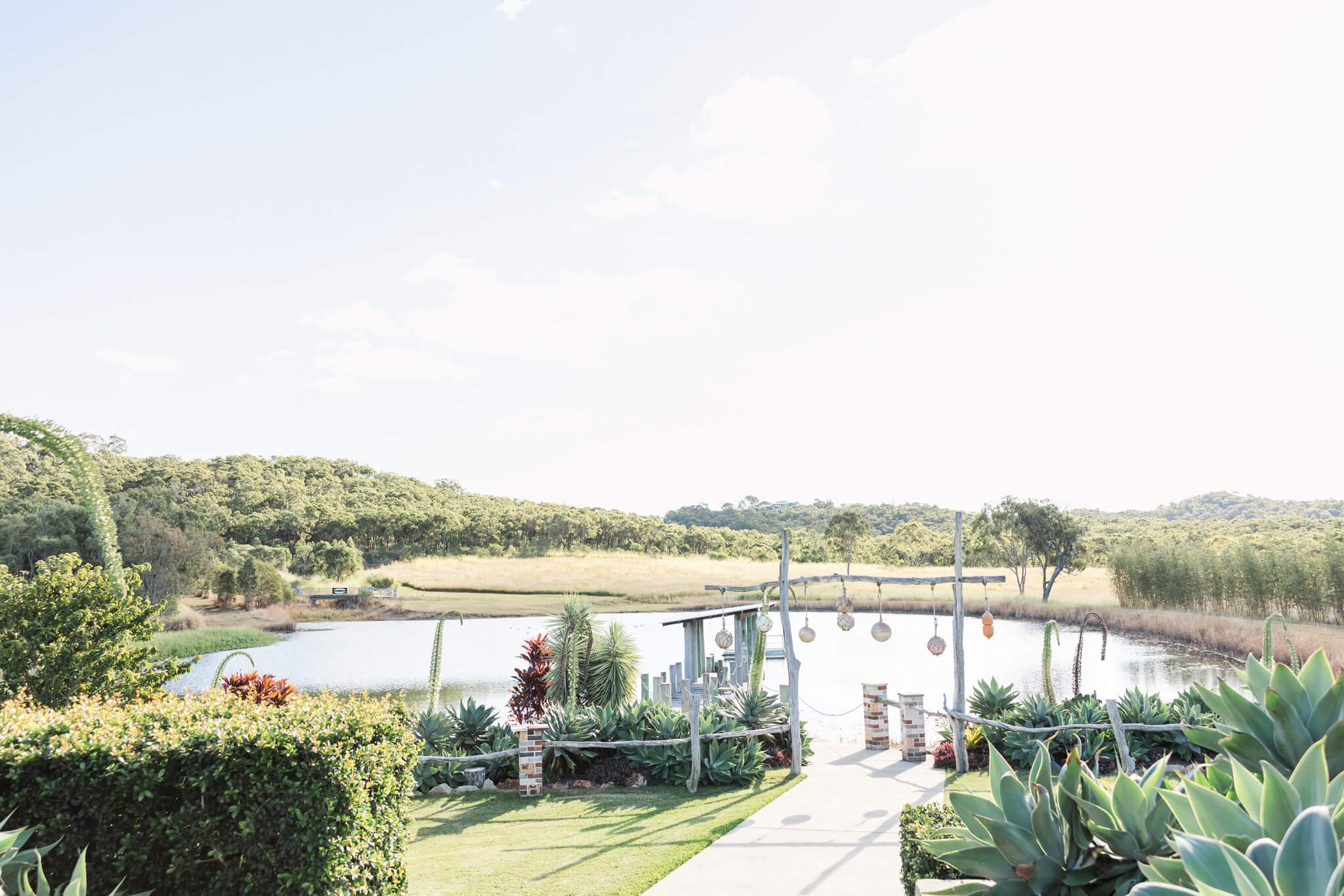 Amazing scenery overlooking a lake at The Salty Lime Co, including a jetty and stunning gardens.
