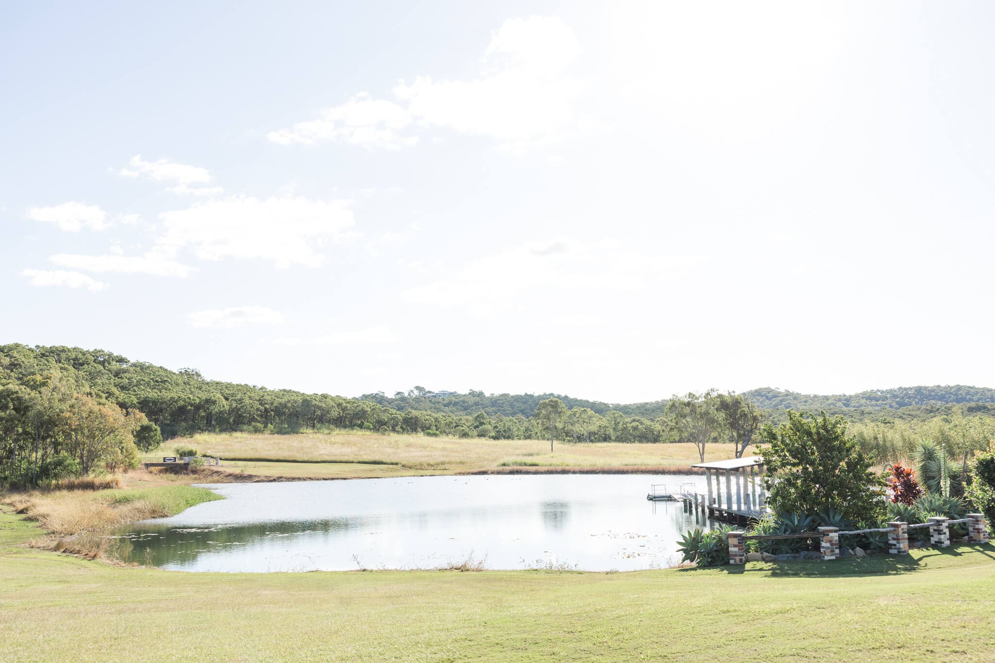 Gorgeous view over looking a lake with a jetty running out into it.