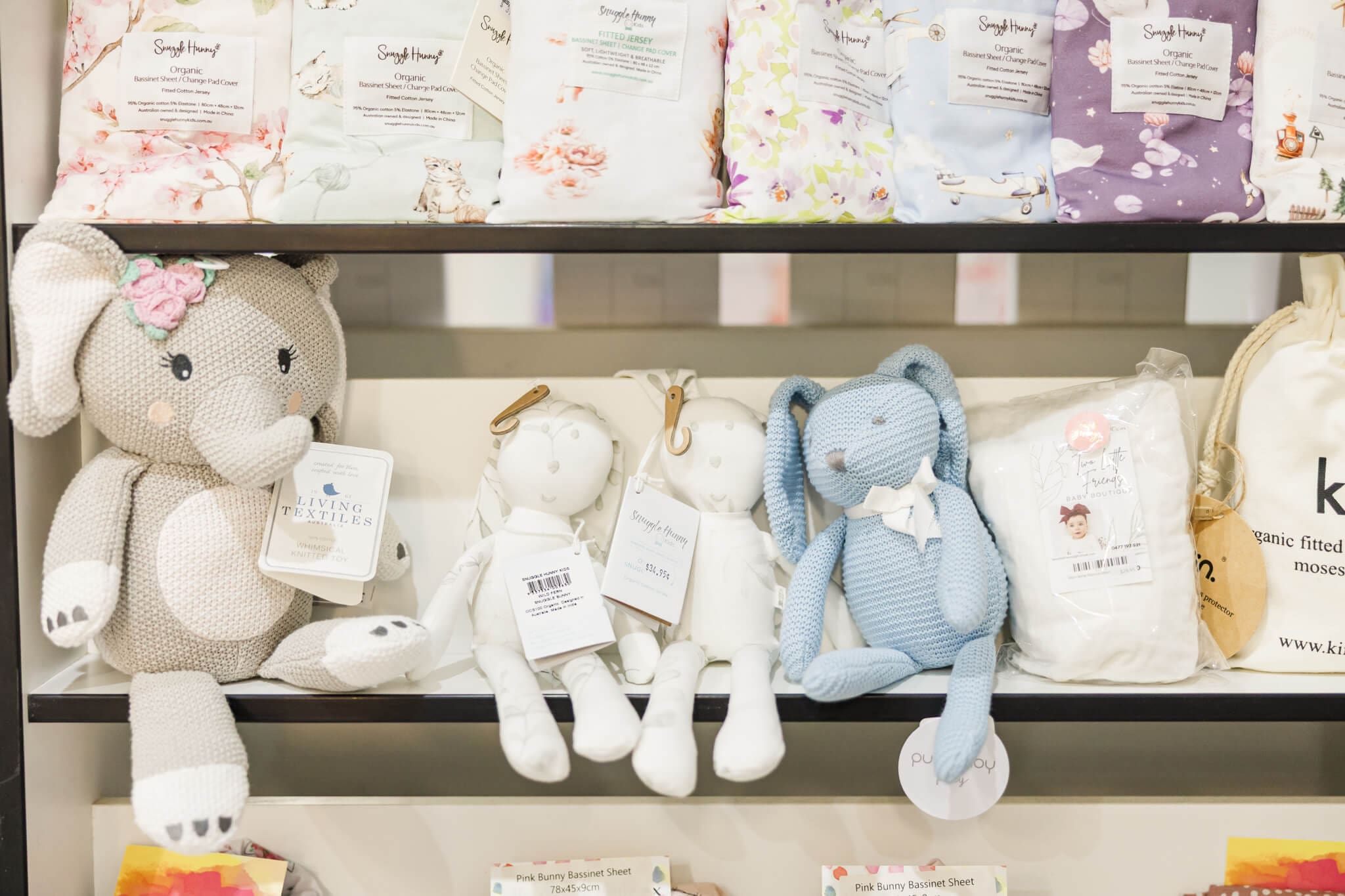 Cute teddies sitting on s shop shelf in a baby shop in Rockhampton.