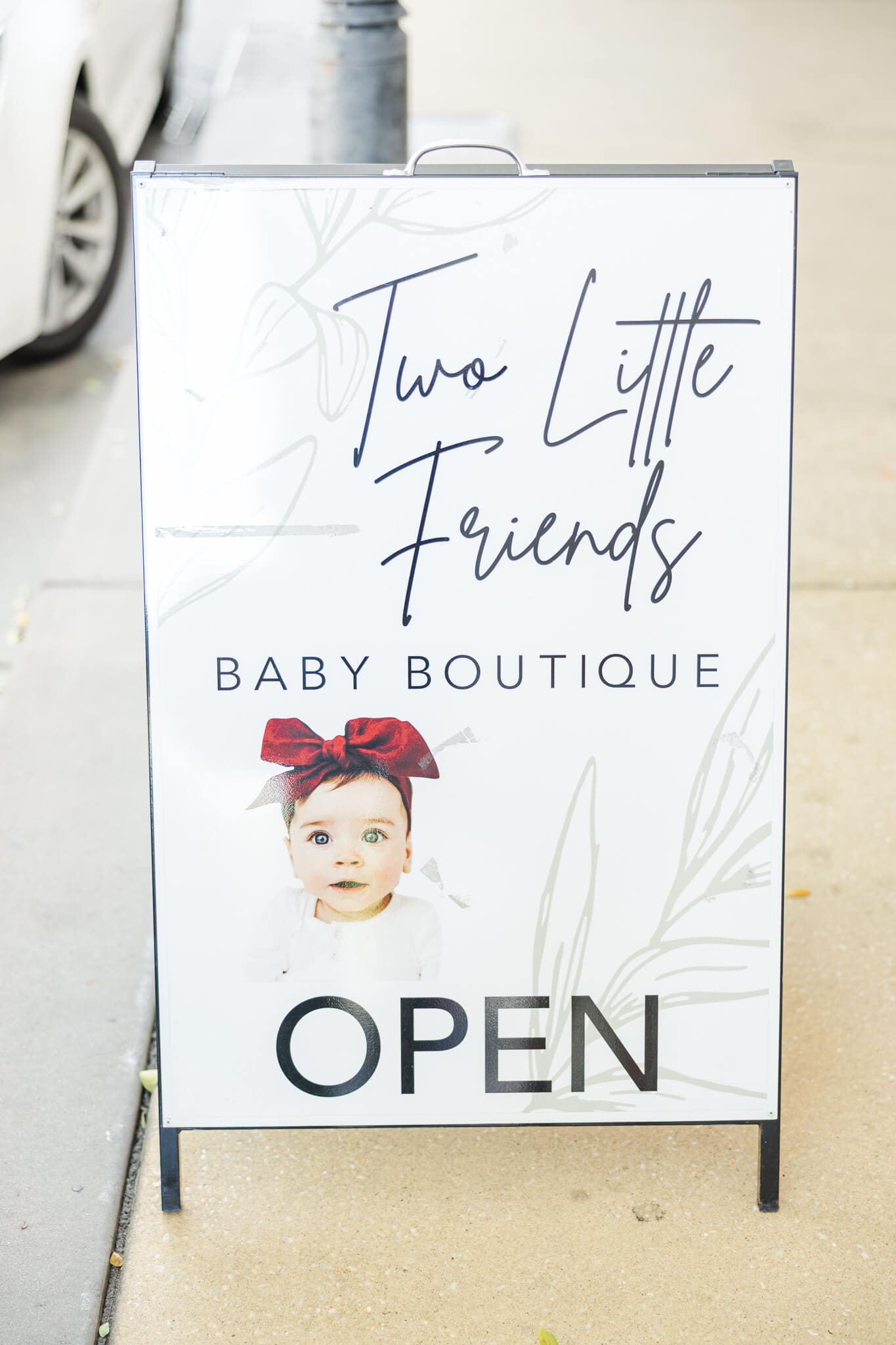 Store sign for Two Little Friends on East Street.