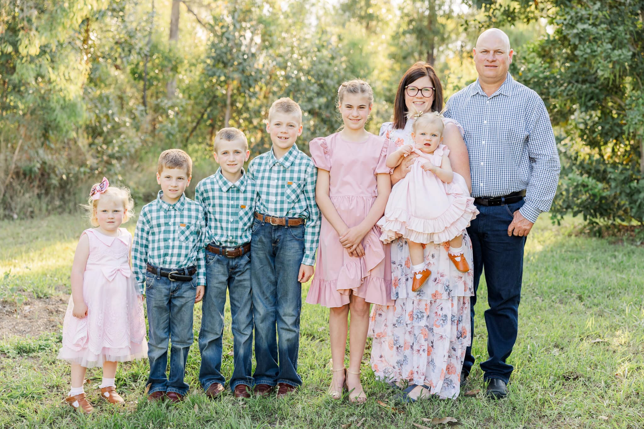 Family of eight, Dad and Mum with six children, standing in a row from tallest to shortest. Captured by Julie-Anne Photography, Queensland Photographer