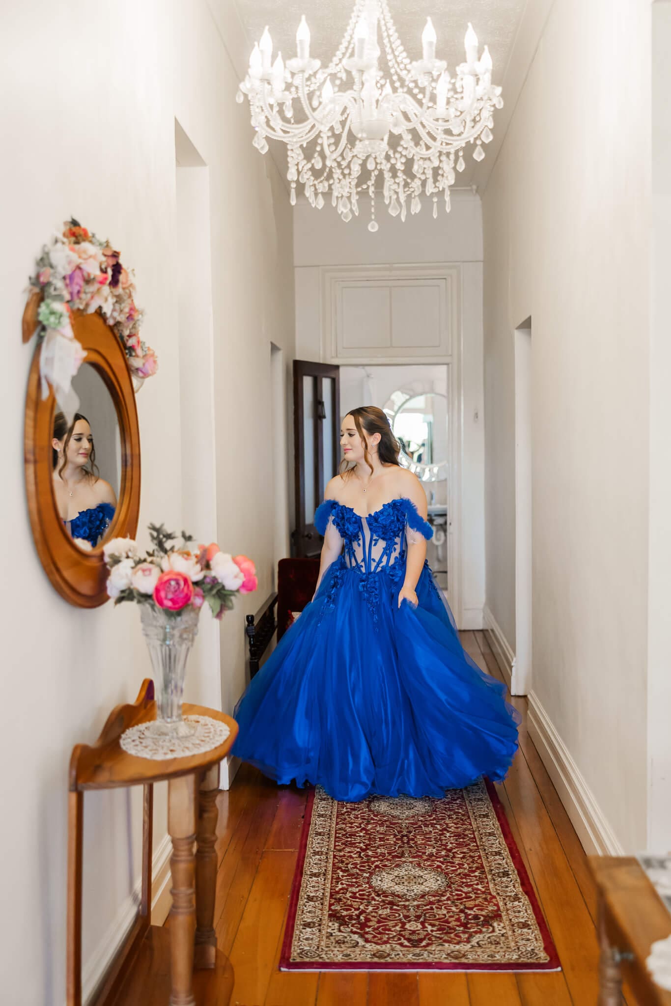 High school senior photo of a girl in a gorgeous blue dress made especially for her formal day.
