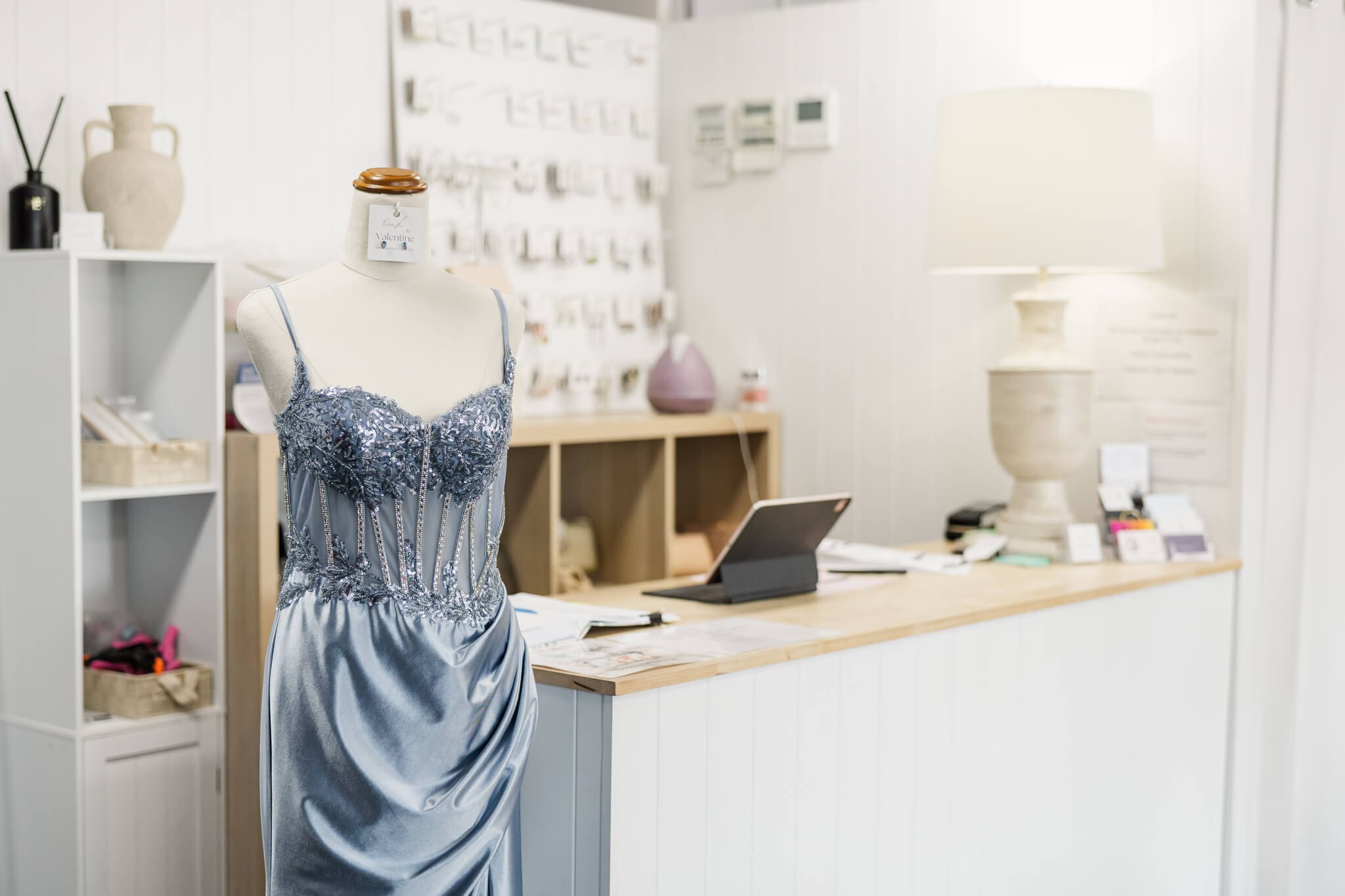 Inside the store of a wedding dress shop in Rockhampton featuring a mannequin wearing a blue formal gown.