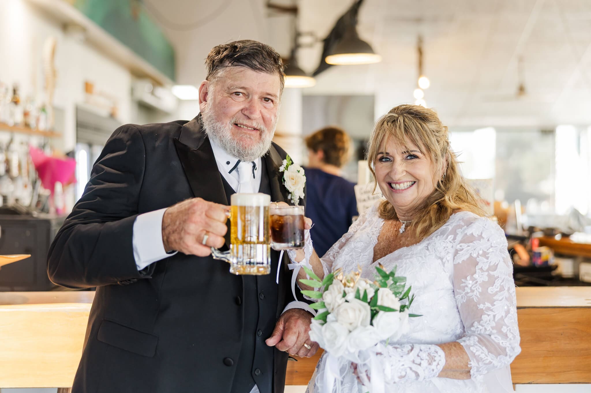 Bride and Groom share a drink at Beaches Restaurant Yeppoon before reception time. Wedding Venue Yeppoon.