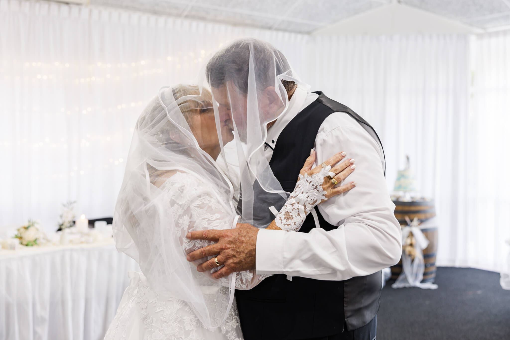 Bride and Groom kiss under the brides veil.