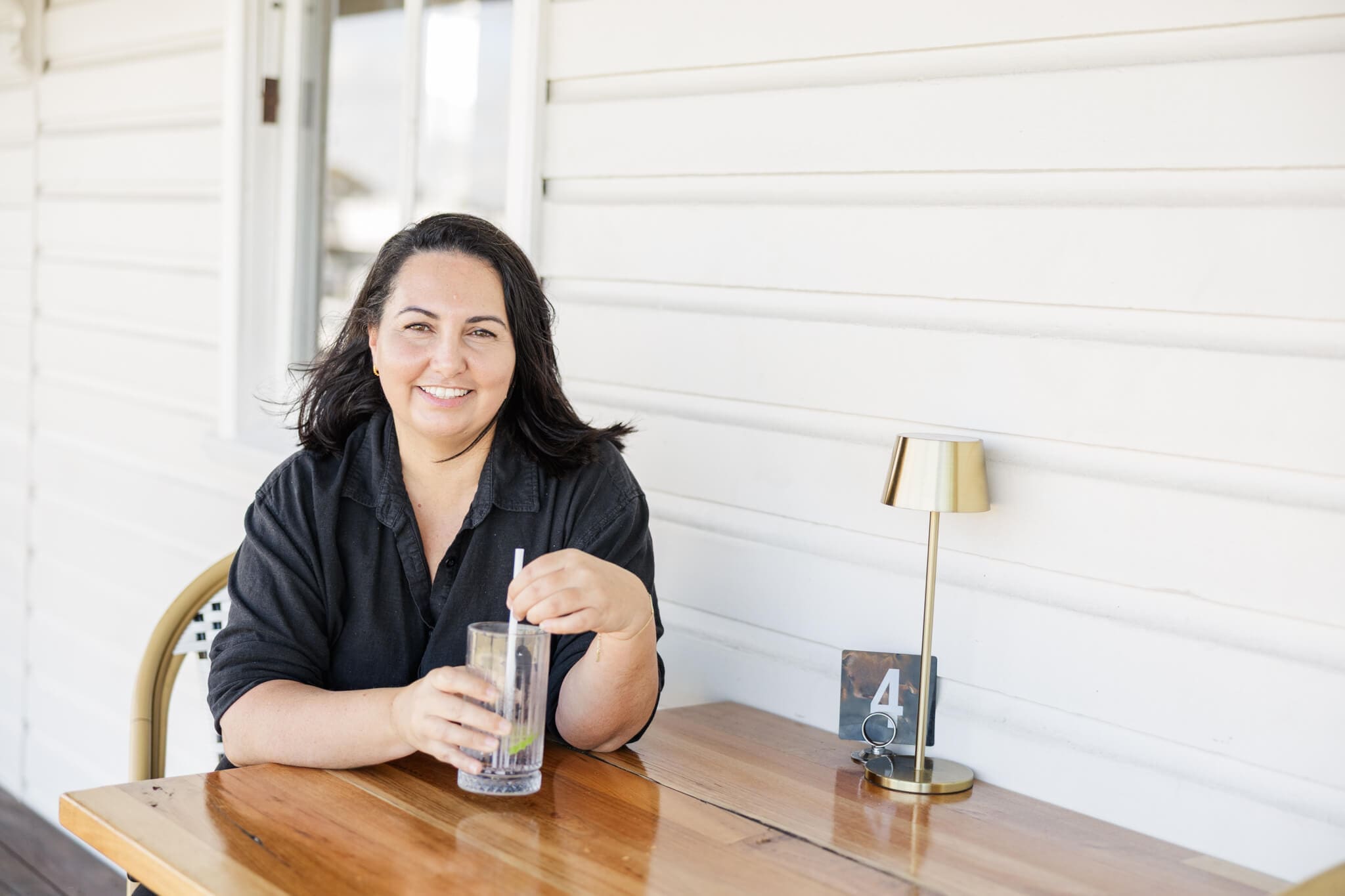 Best Day Ever Events planner, Gina, sitting down at a table ready to chat. Captured by Julie-Anne Photography.