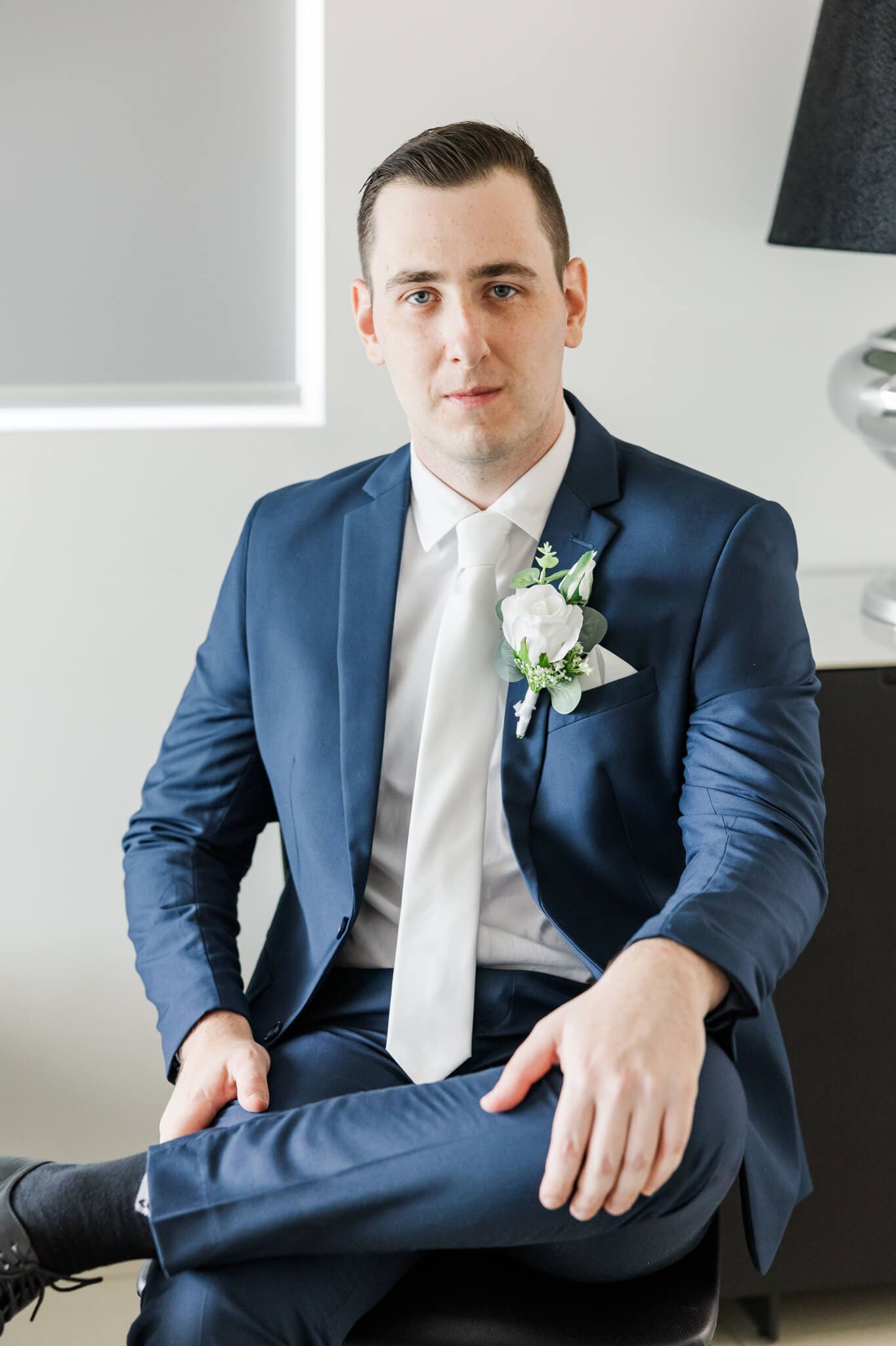 Groom poses for a shot for his wedding portraits. Captured by Julie-Anne Photography