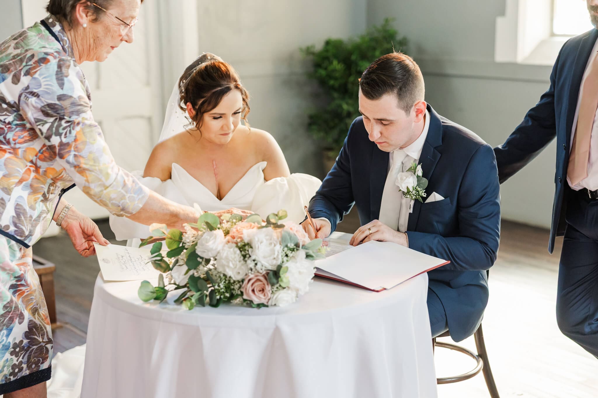 Wedding portrait of the couple signing their wedding papers.