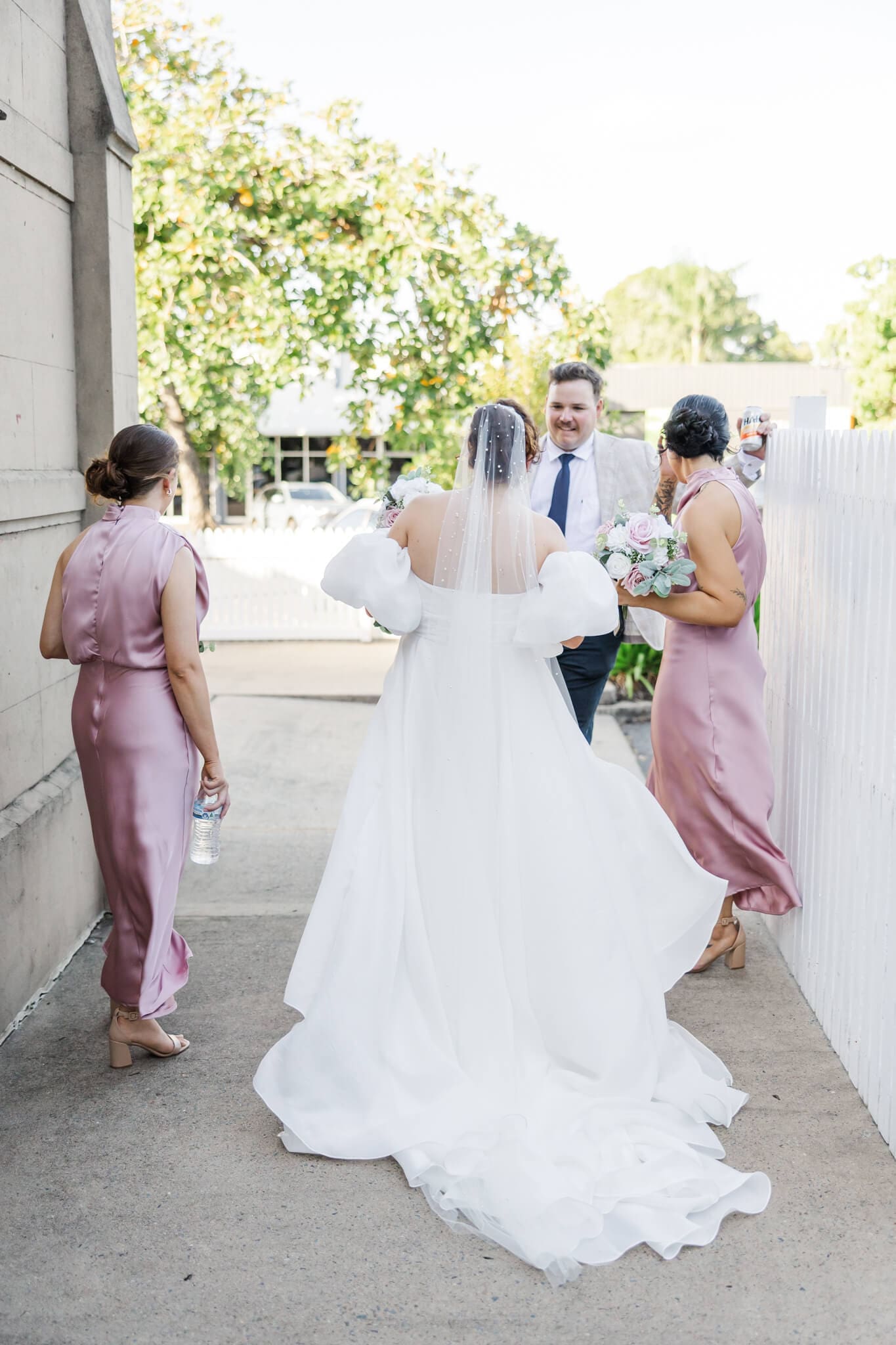 Candid shot of the bride hanging out with her bridesmaids at her wedding. Located at The Church Events Venue in Rockhampton.