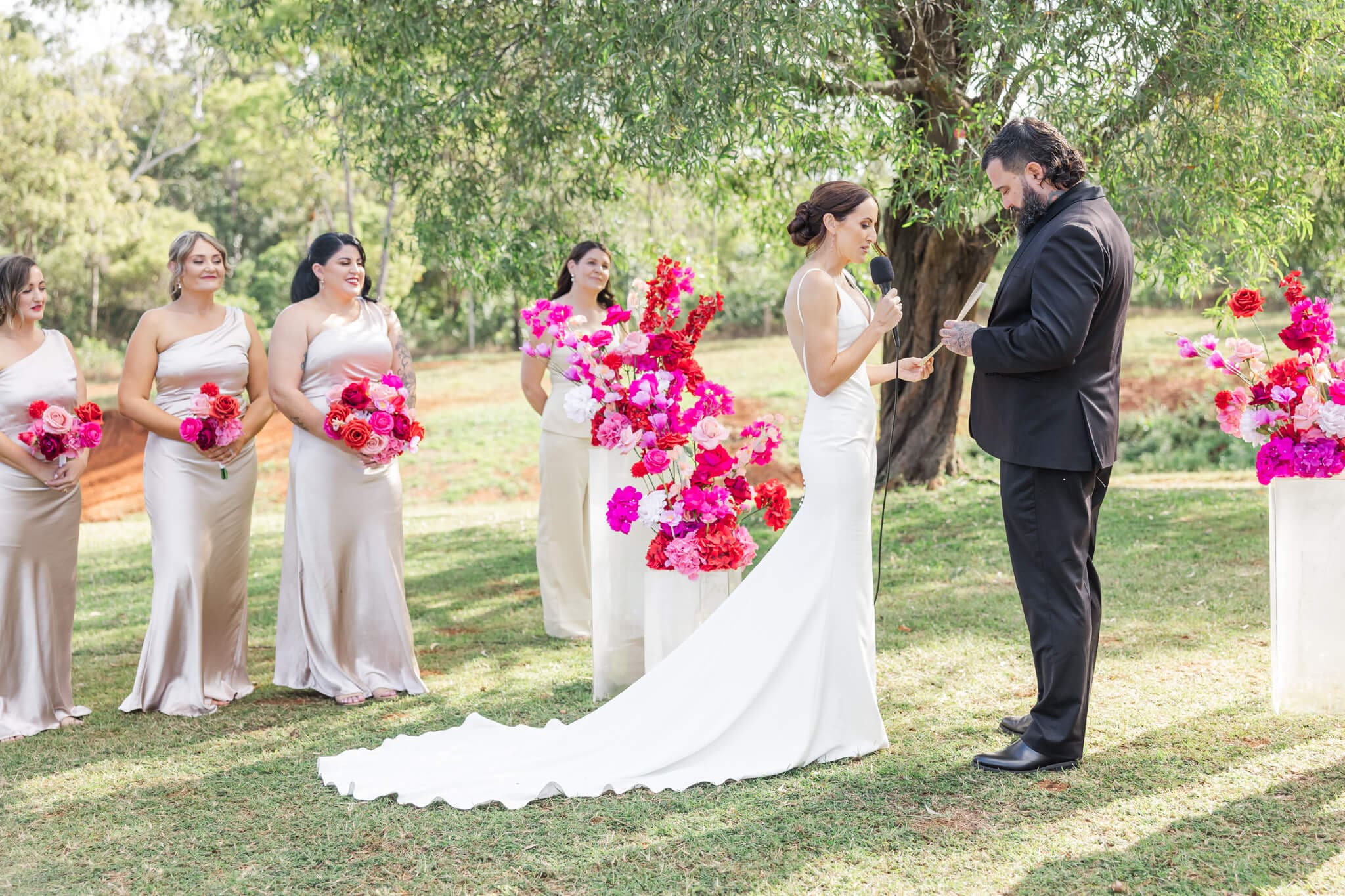 Bride and Groom exchanging vows during their wedding ceremony at The Orchard Yeppoon.