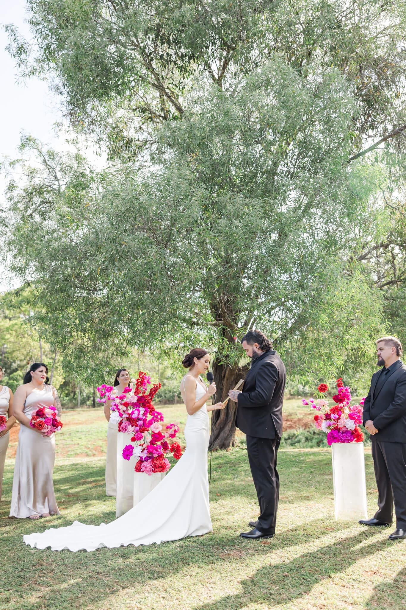 Bride and Groom exchanging vows during their wedding ceremony at The Orchard Yeppoon.