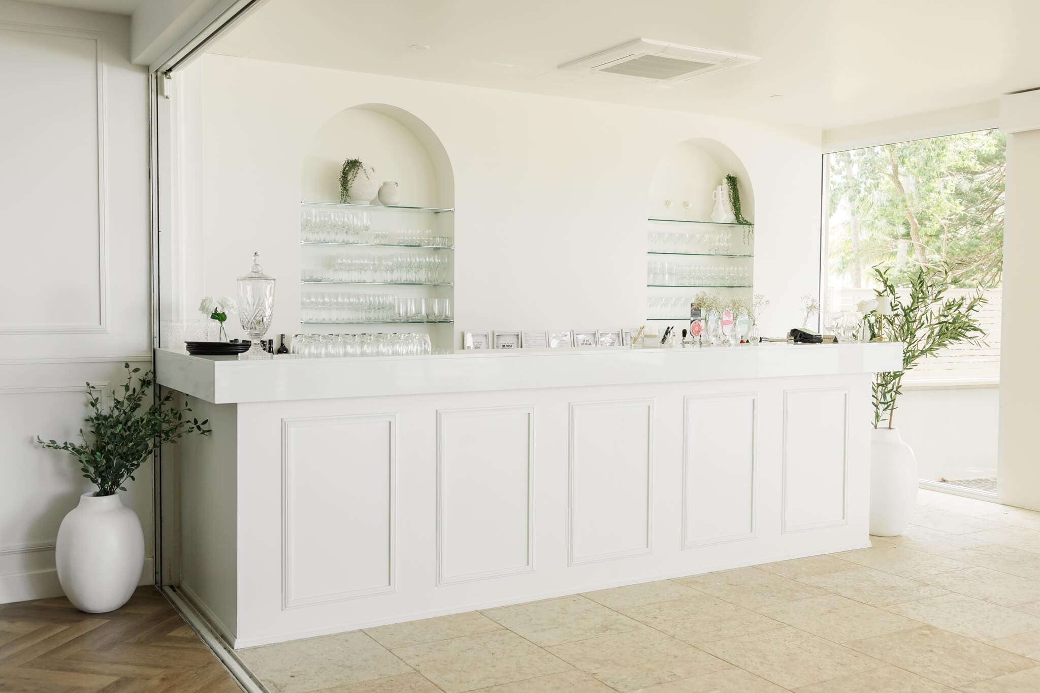 Inside a wedding venue near Yeppoon, showing a serving counter at a bar. White decor and gorgeous details captured by Julie-anne Photography.