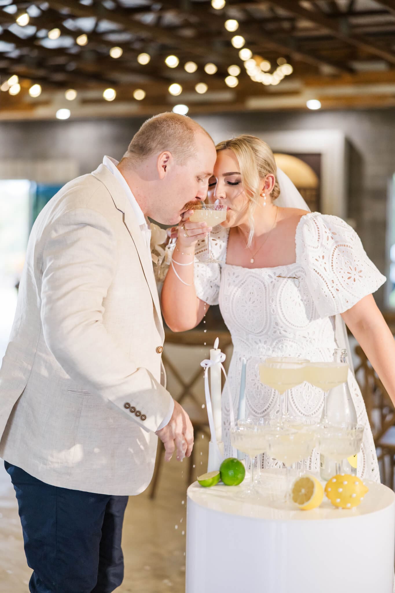 Bride and Groom share a drink at their champagne tower. Captured at The Salty Lime Co. by Julie-Anne Photography.