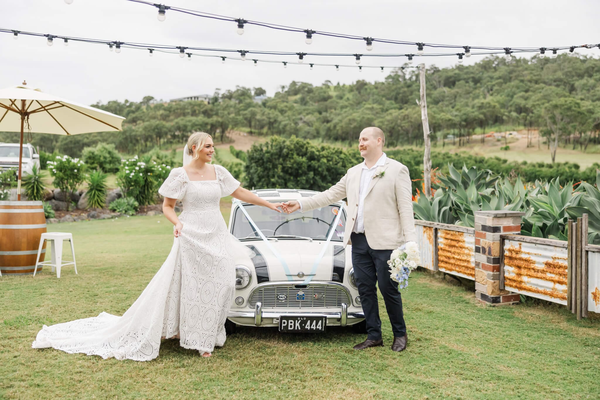 Bride and Groom next to an old fashioned car at The Salty Lime Co,  a Yeppoon wedding venue.