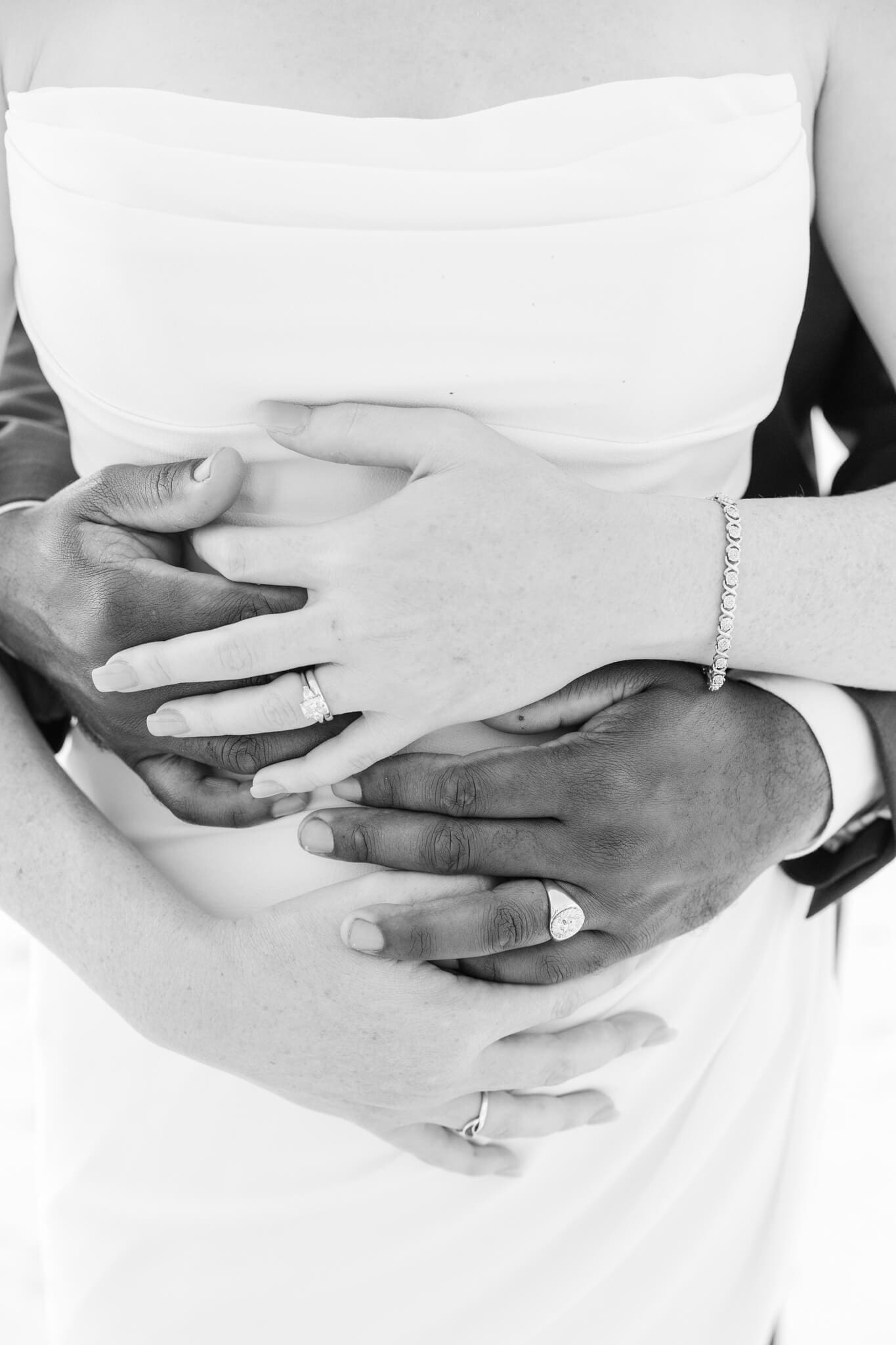 Detail shot of Bride and Grooms hands showing their wedding rings.