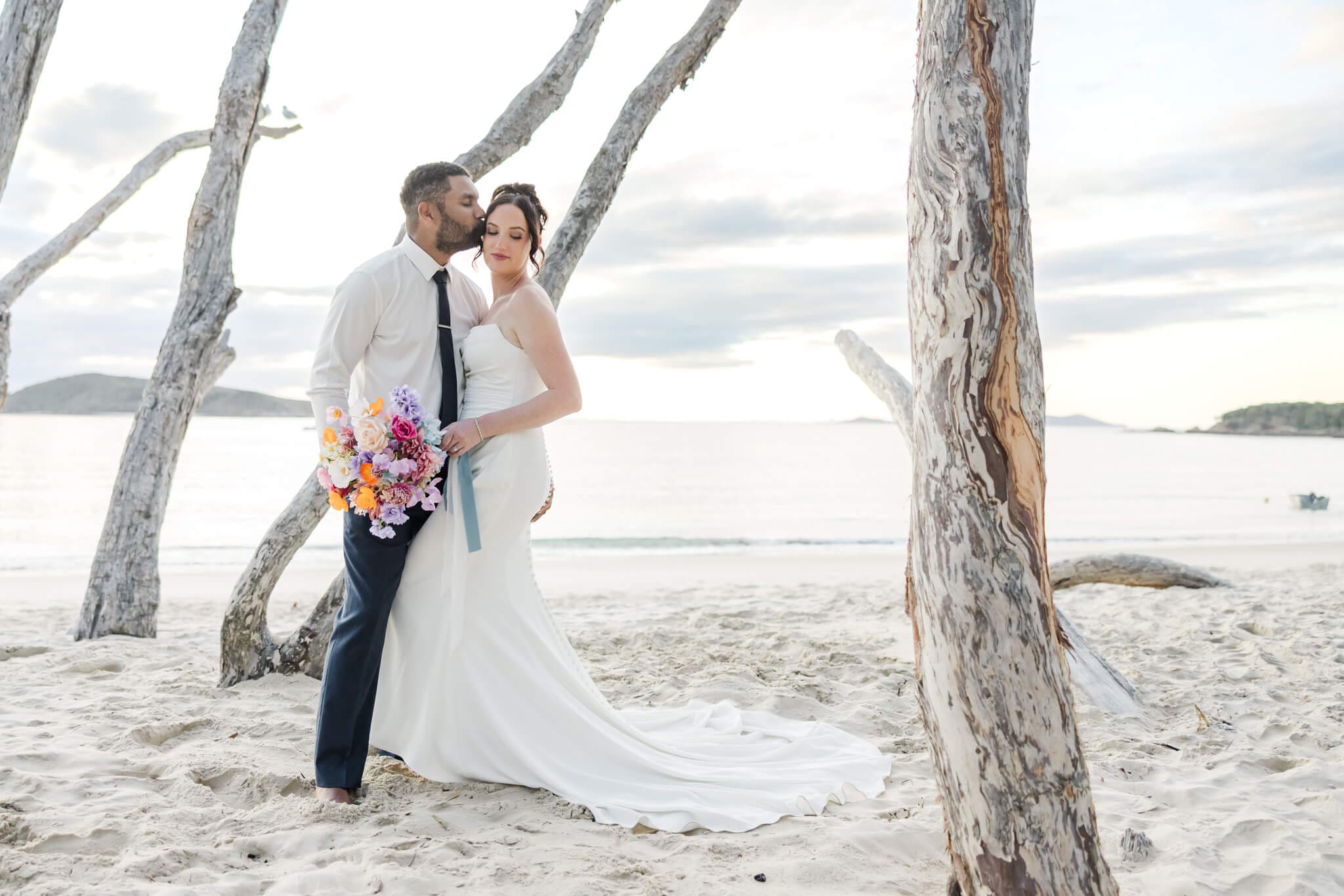 Bride and Groom share a moment on Great Keppel Island during their wedding day. Pictured in front of one of the beaches near Great Keppel Island Hideaway.