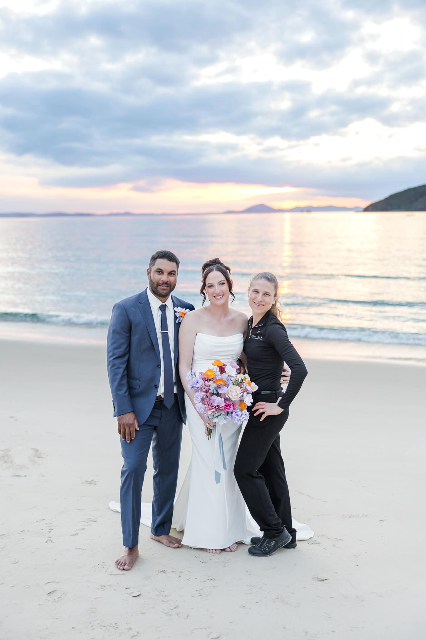 Julie-Anne - Yeppoon Wedding photographer, posing with her bride and groom for a shot at their sunset portrait session.