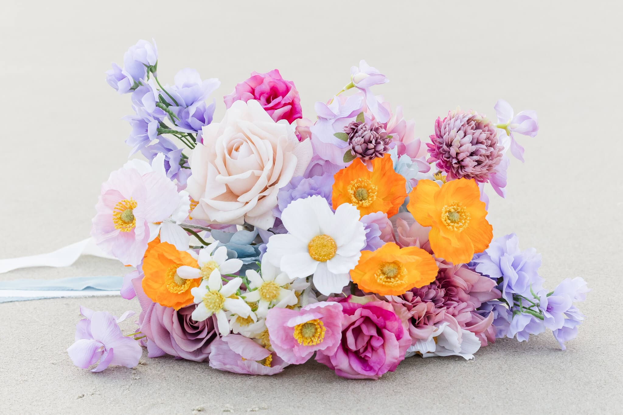 Close up portrait of a brides bouquet lying on the beach at Great Keppel Island Hideaway.