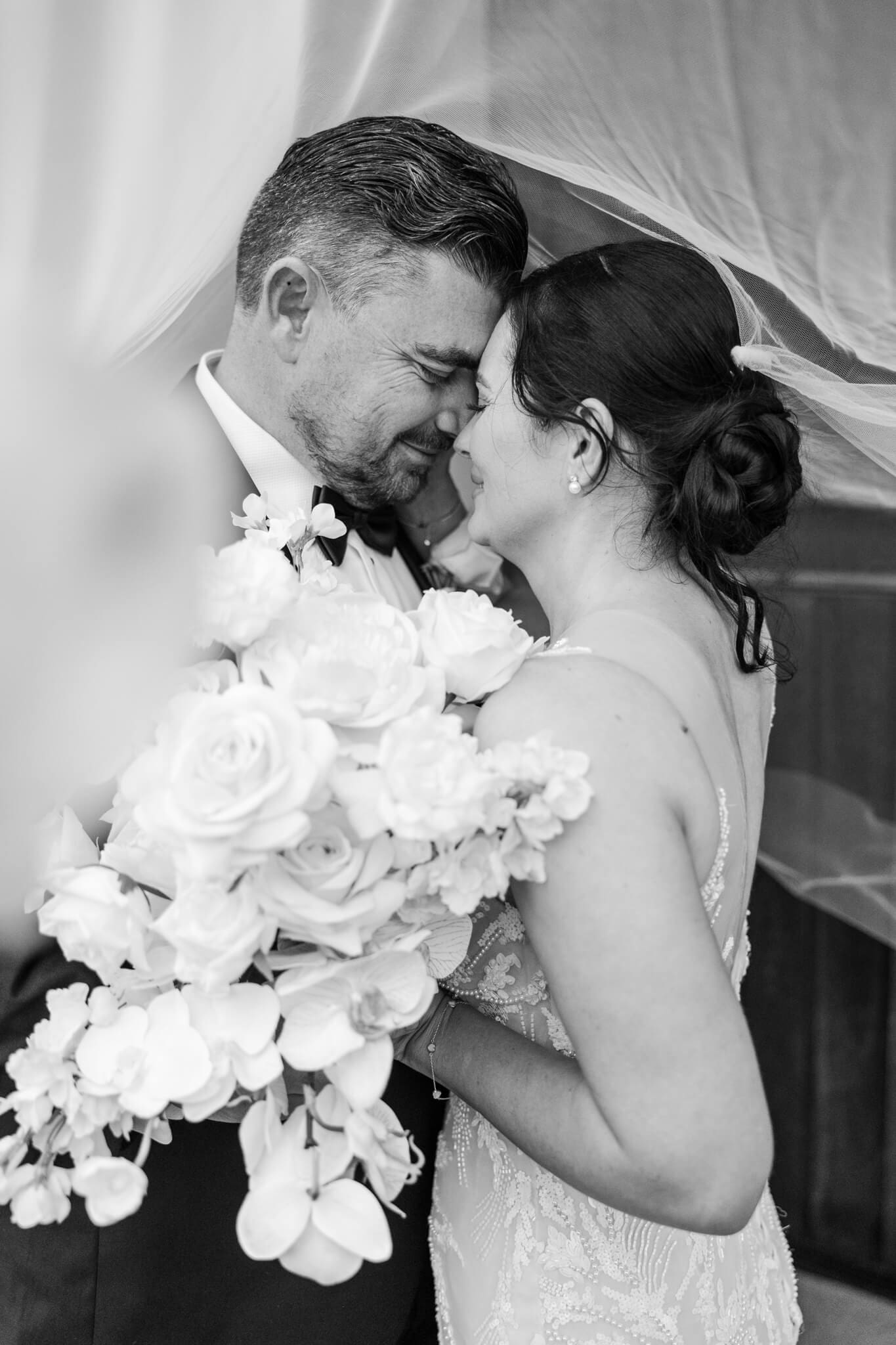 Bride and groom at a Headricks Lane on their wedding day enjoying an embrace. Black and white image captured by Julie-Anne Photography