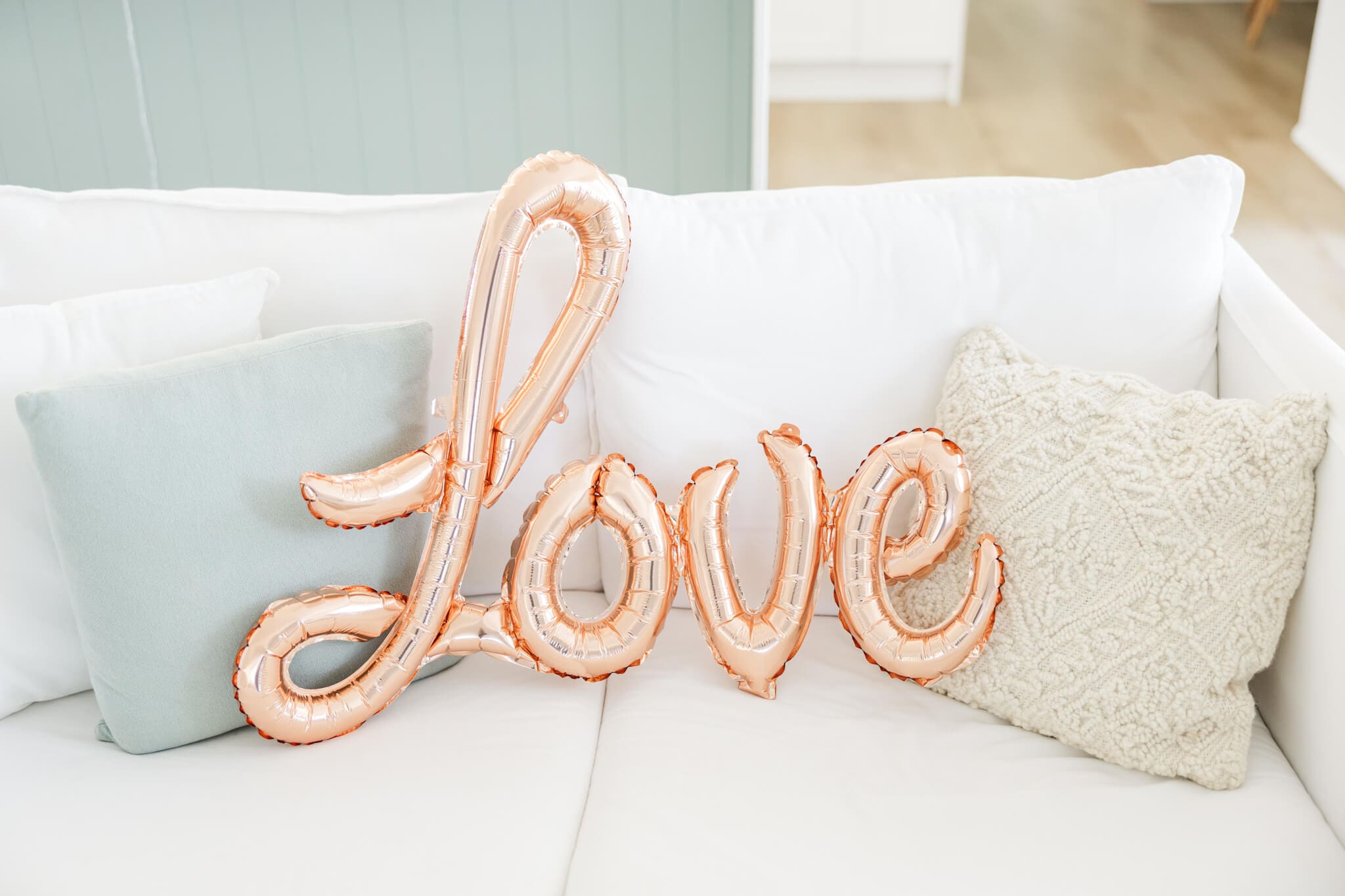 The word 'love' as a balloon on a sofa. 