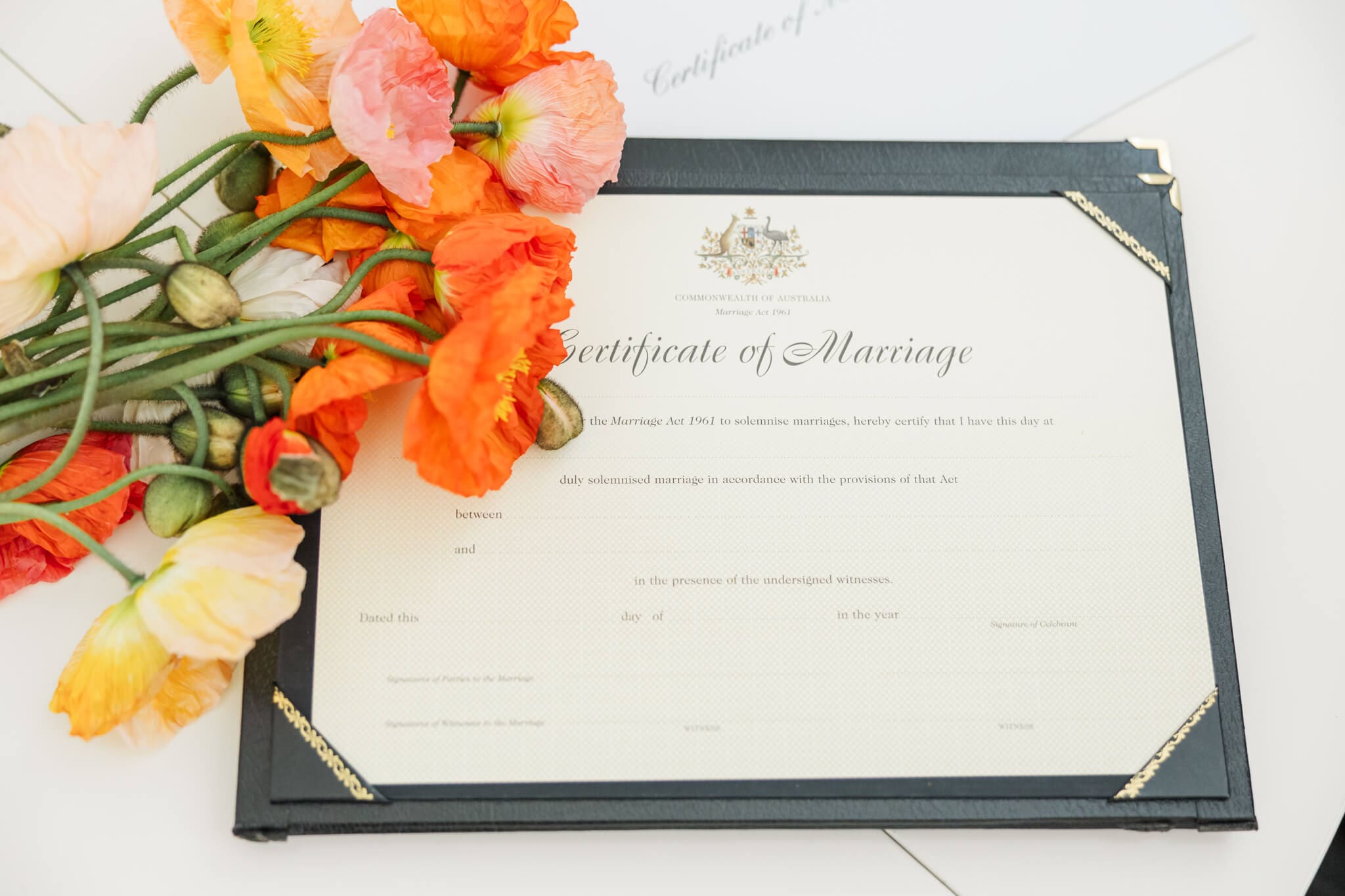 Certificate of marriage decorated with a bunch of poppies.