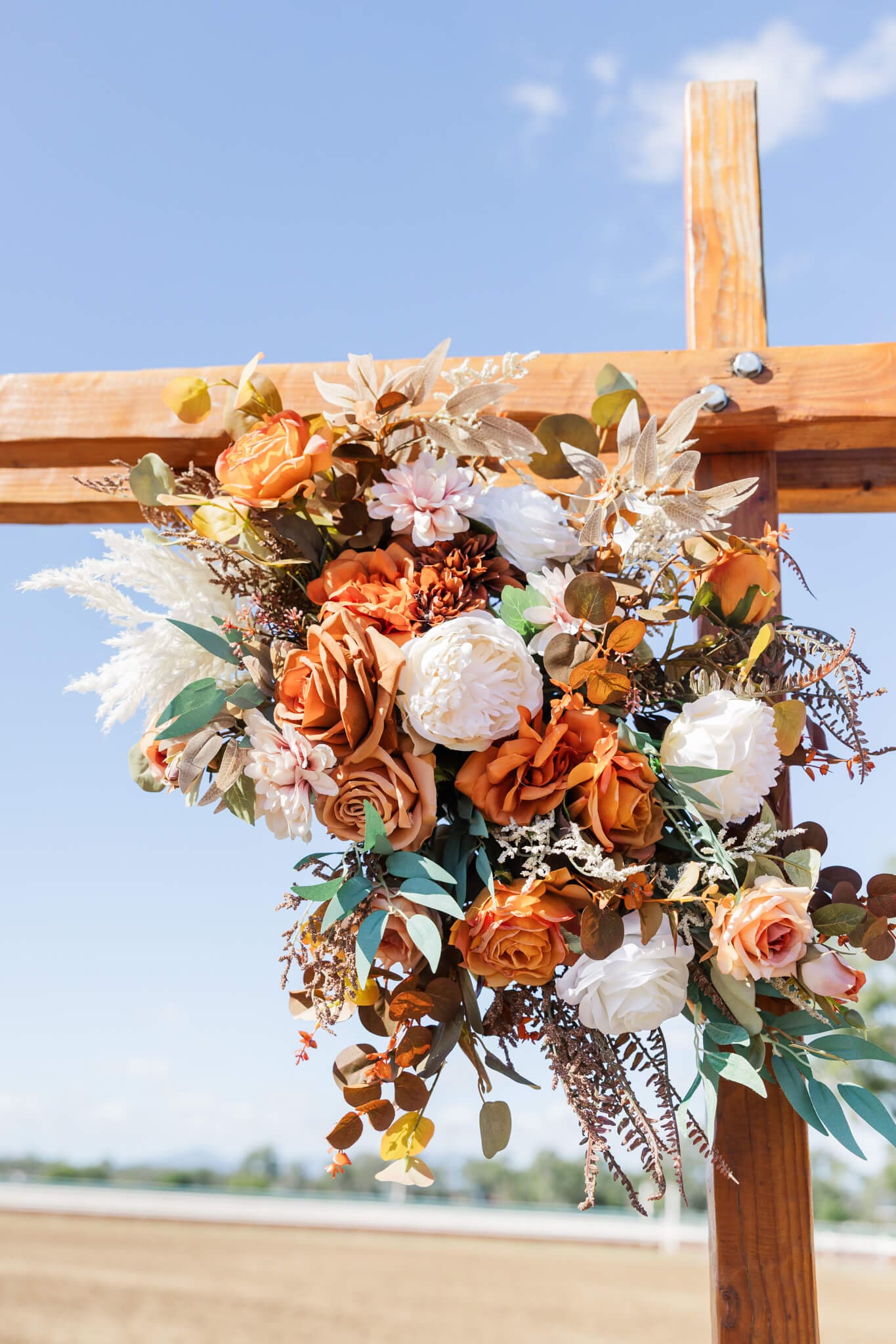 Beautiful bouquet of flowers on a wooden arbour, ready for a wedding.