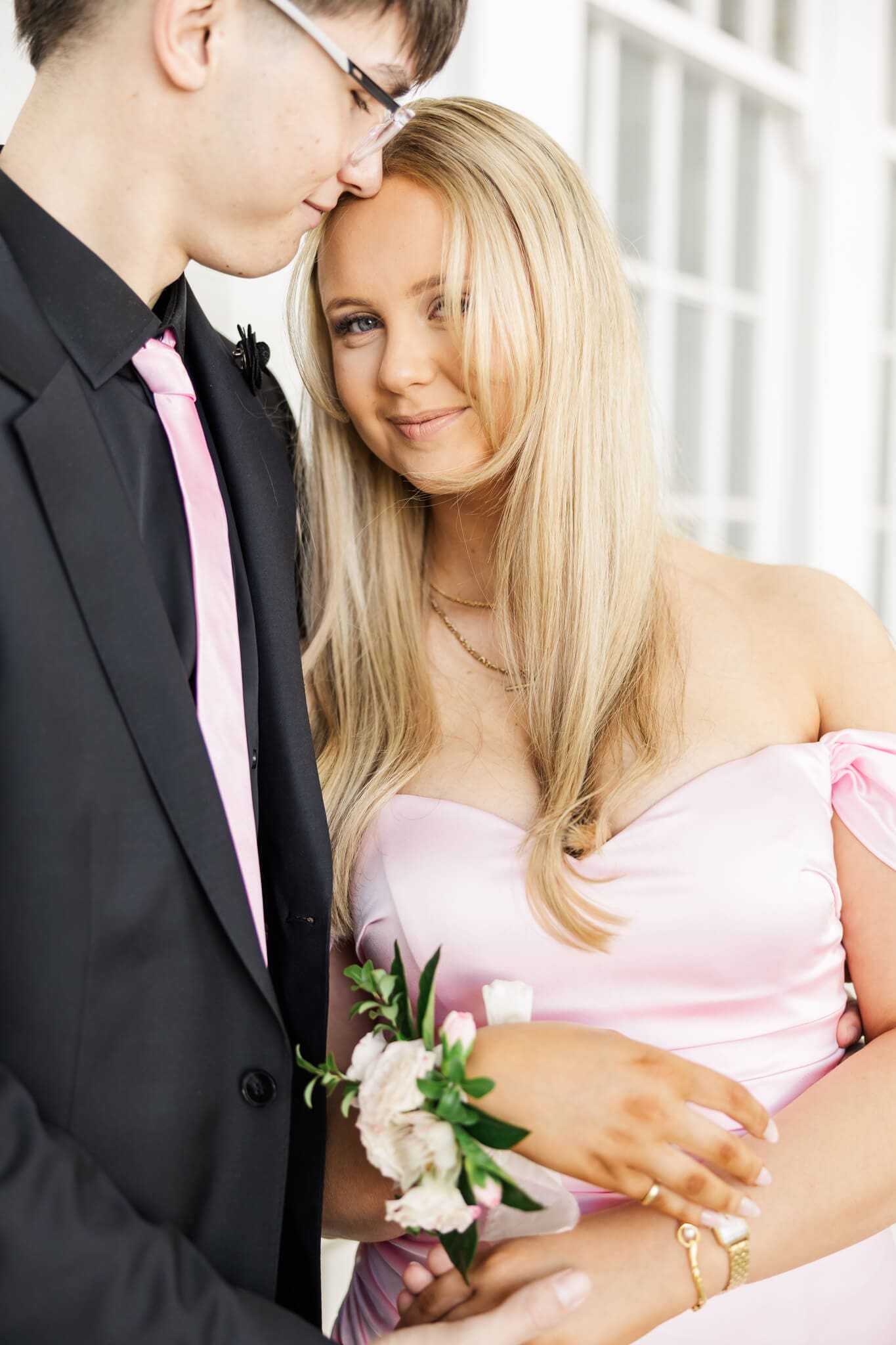 Beautiful portrait on formal day of a girl graduate in a close embrace with her partner. 