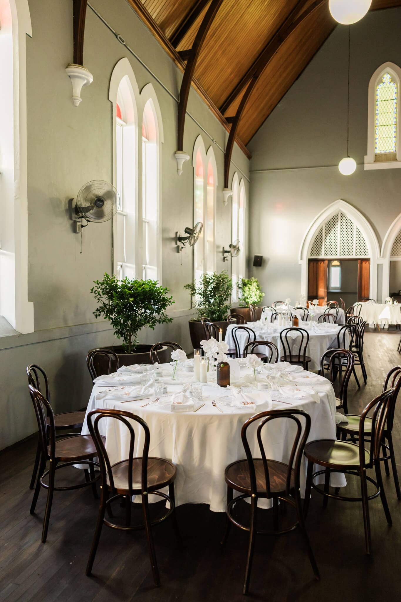 Beautiful hire pieces by Little List + Co, a wedding hire Rockhampton business. Wedding reception tables decorated with napkins, table linen, vases, florals and other decor.