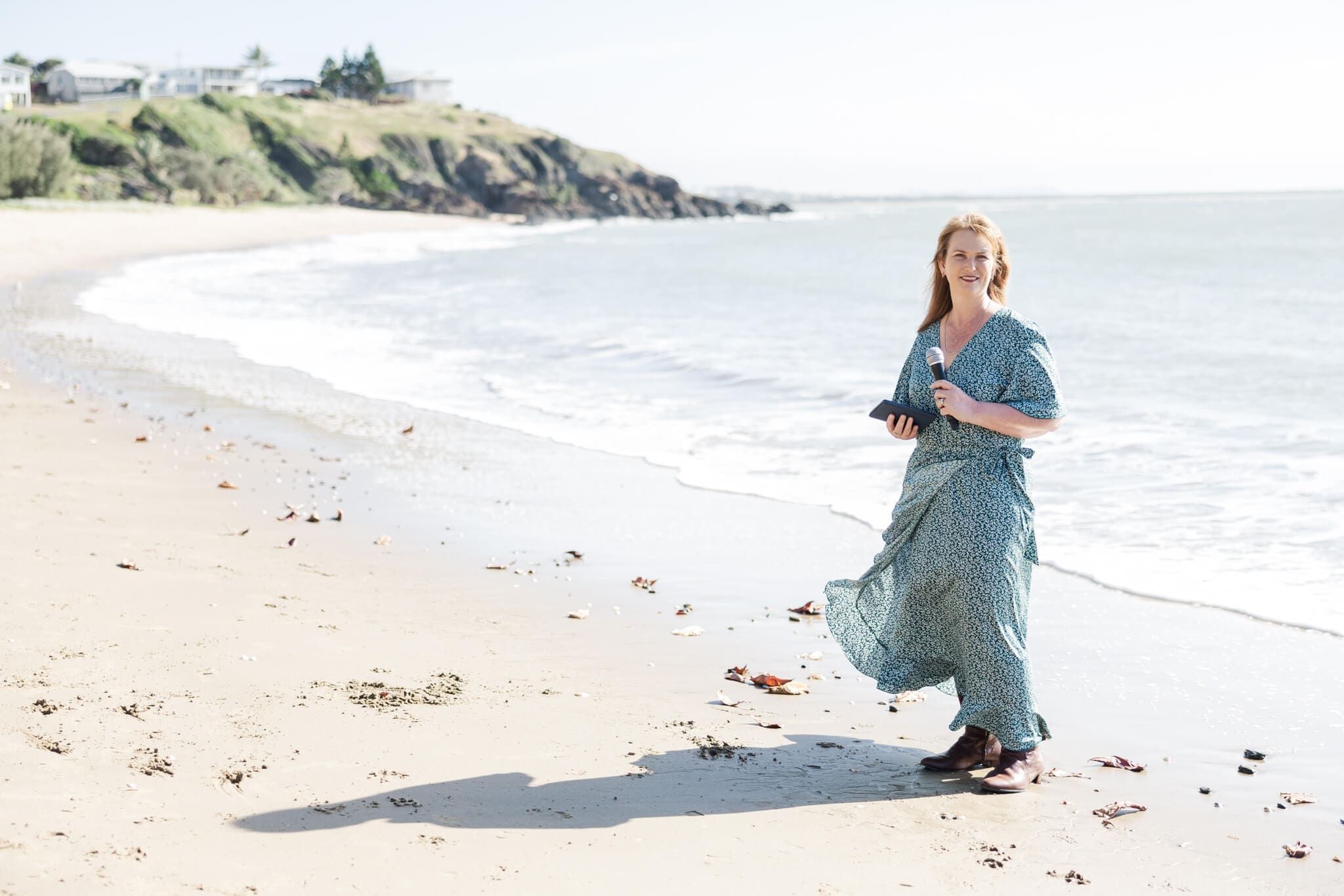 Wedding Celebrant Heather Sanders stands on the Cooee Bay Beach near Yeppoon, Queensland.