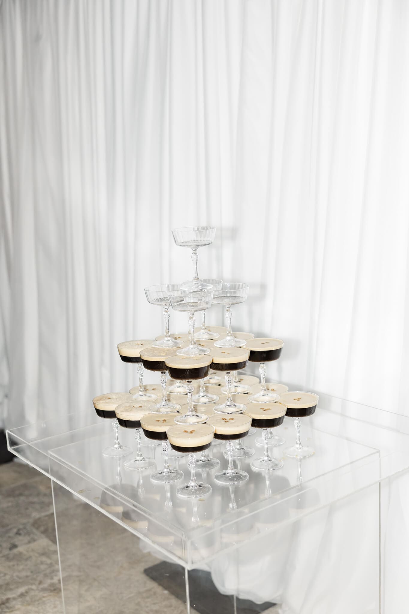 A champane tower ready for the bride and groom to fill at a wedding reception.