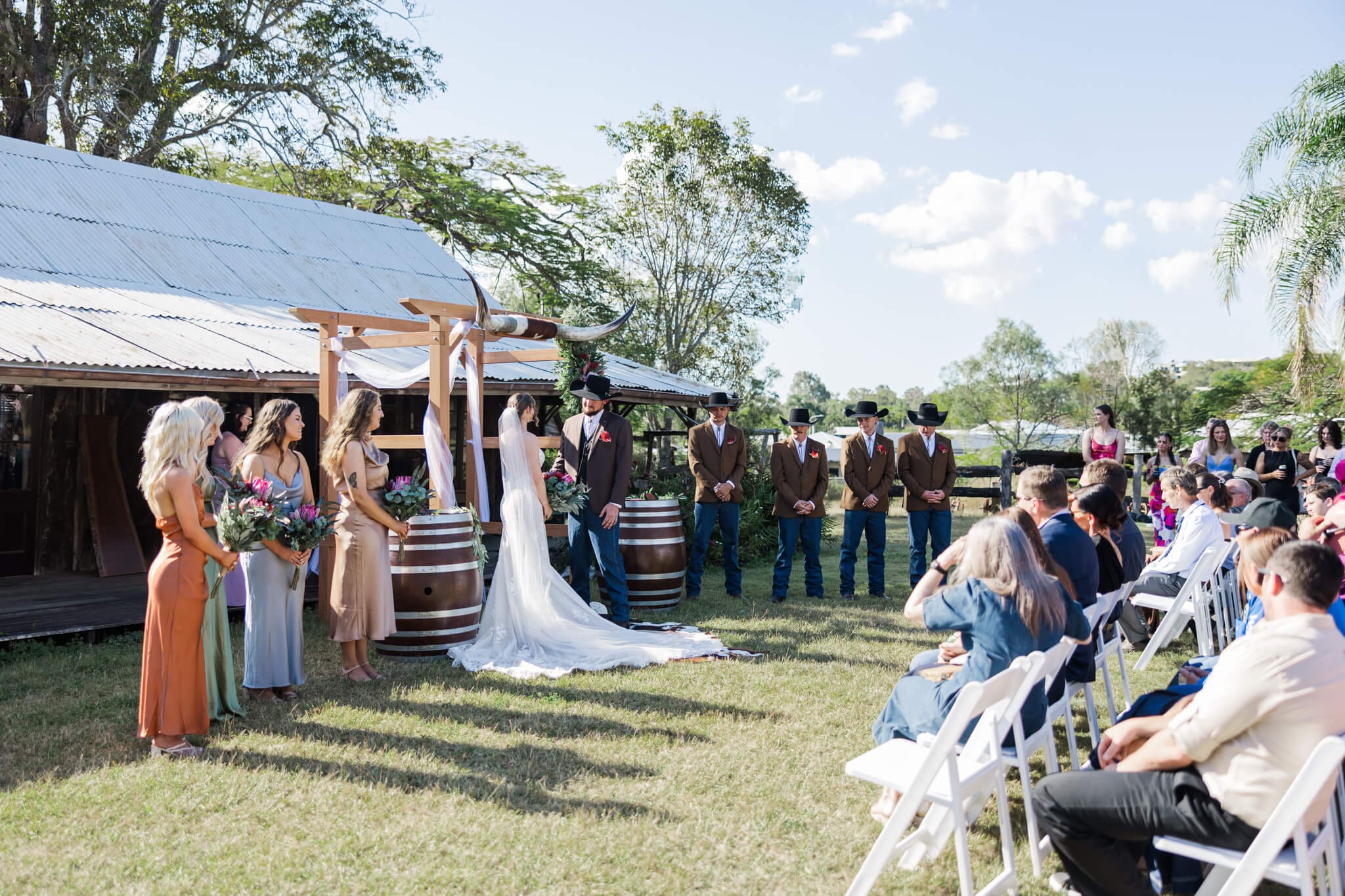 Wedding ceremony being held at the Glenmore Homestead Rockhampton, in front of one of the old homesteads that remain there.