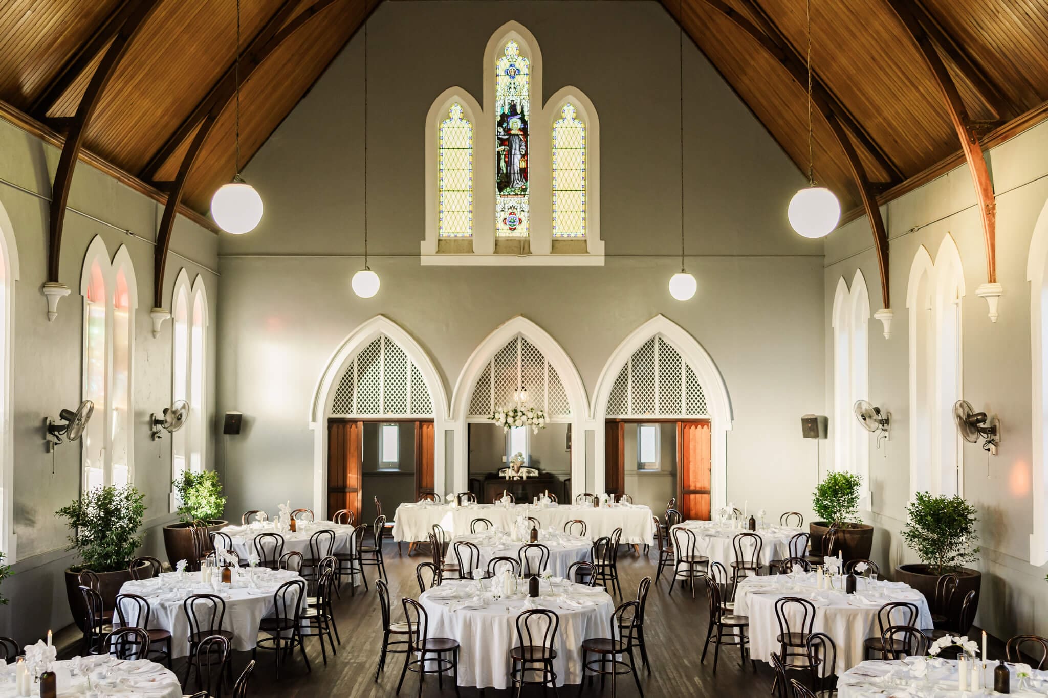 Magnificent Rockhampton wedding venue called The Church Events Rockhampton. Gorgeous table settings styled with white table linen and florals.