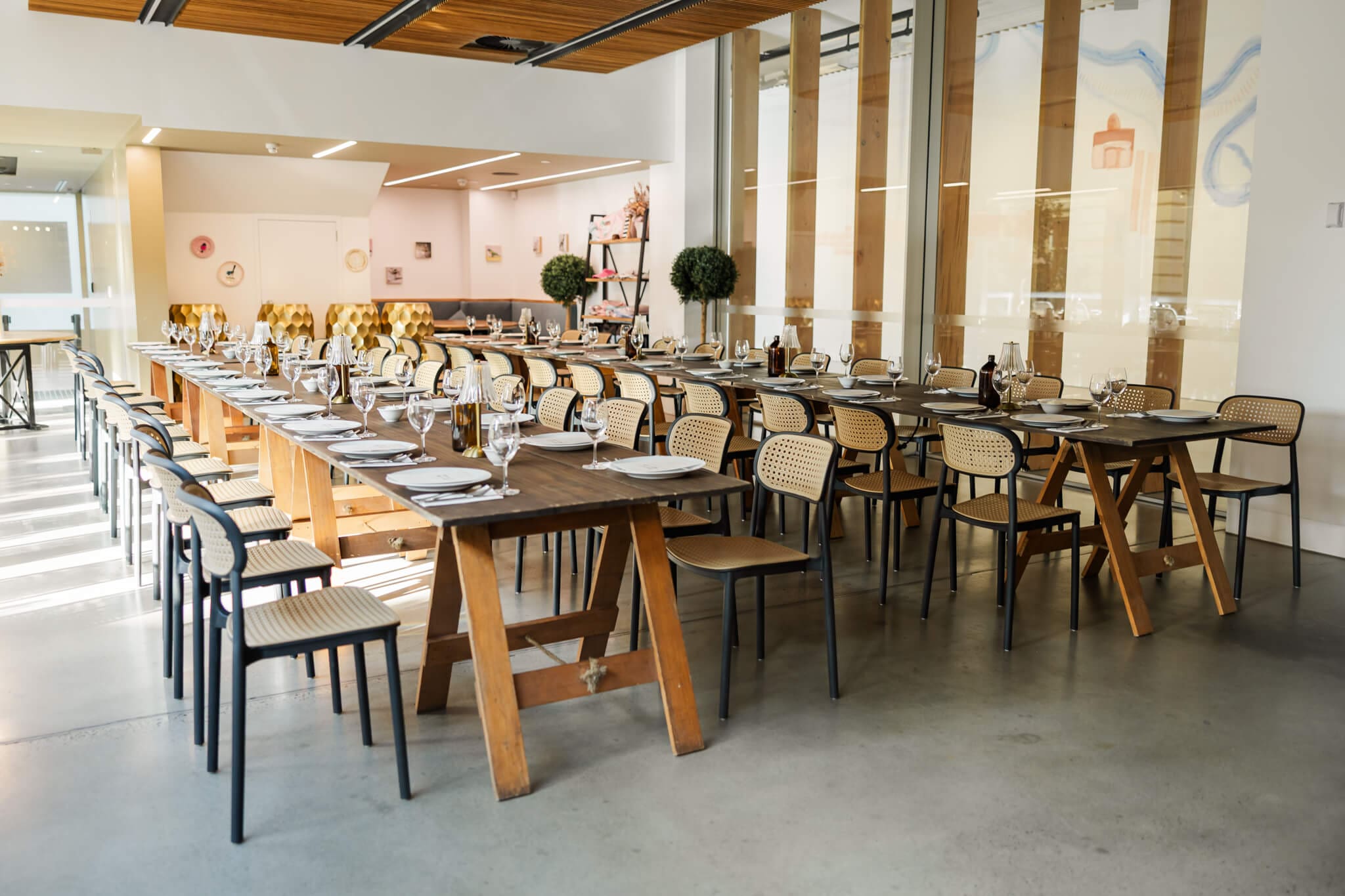 Elegant reception set up featuring wooden tables and beautiful lamp style centre pieces in a cafe style setting.