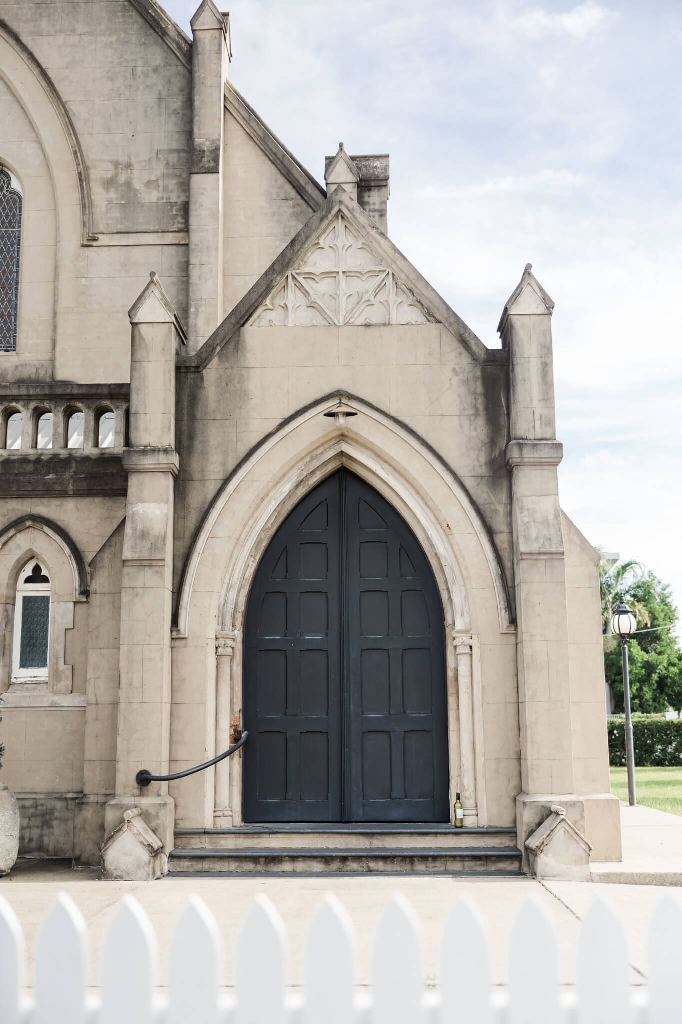 Entrance to the Church Events Rockhampton featuring a regal black door and exquisite archways.