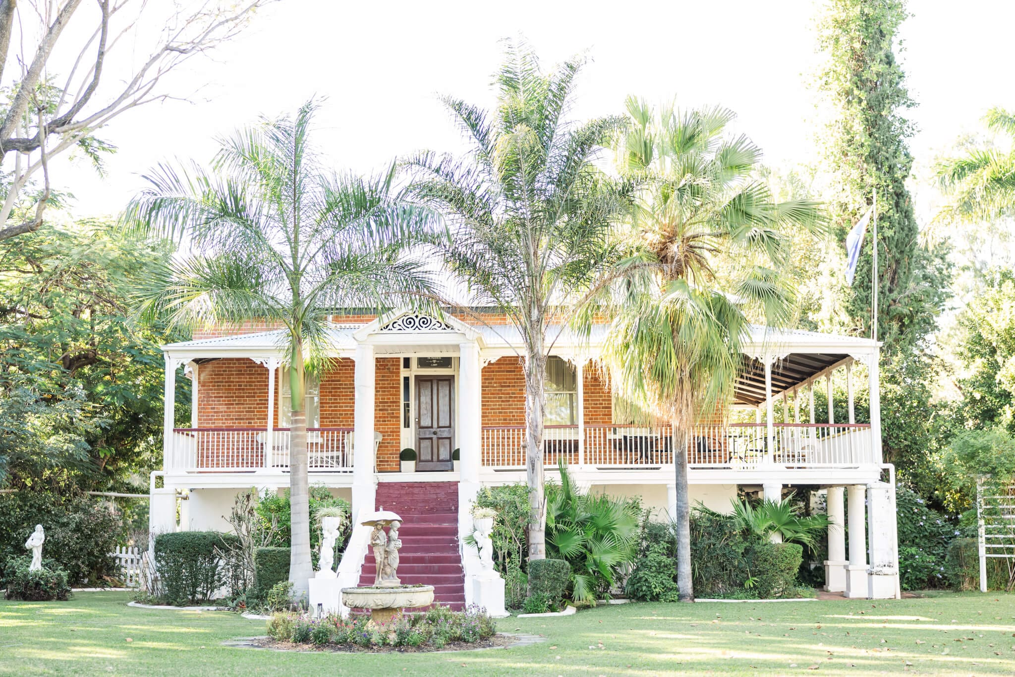 Main homestead at St Aubin's village, one of many Rockhampton wedding venues. Stunning old fashioned double story home surrounded by lush gardens.