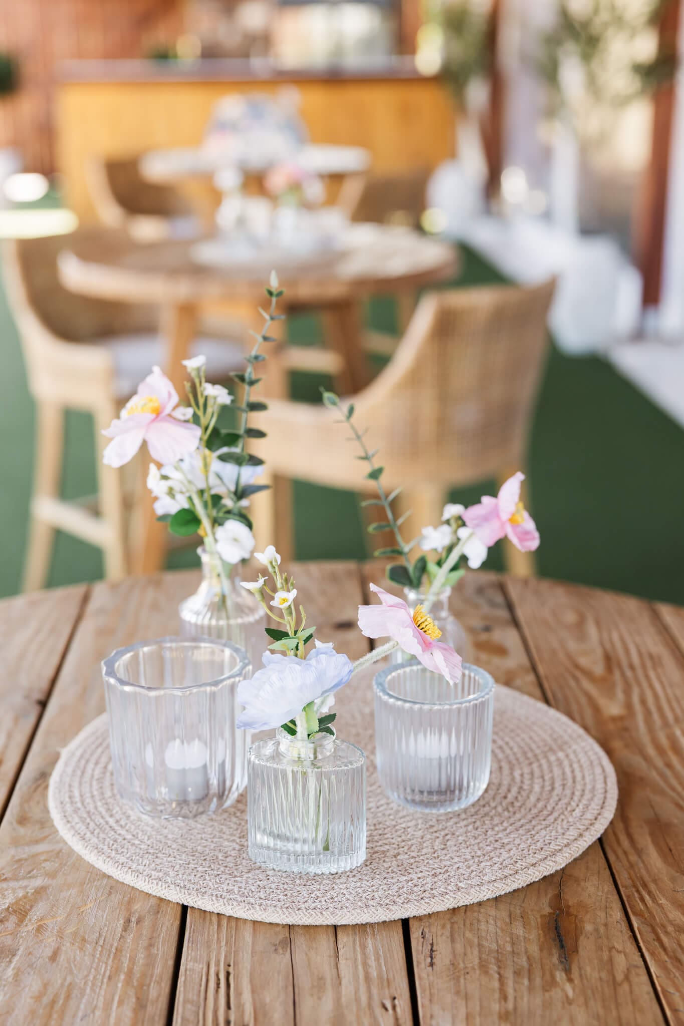 Detail shots of wedding hire Rockhampton items by Little List + Co including florals in small vases on a wooden table.