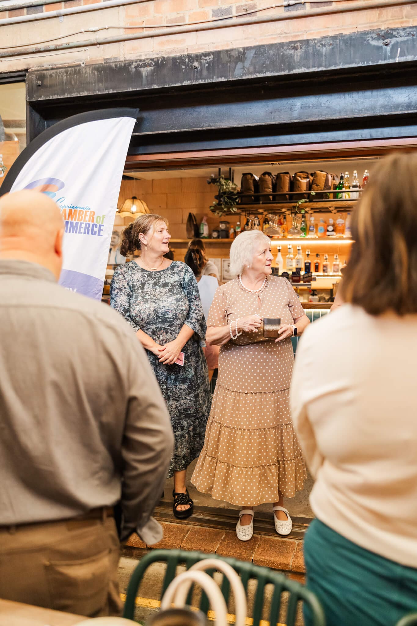 Business men and women drink coffee and network at an event at The Alley, Yeppoon.