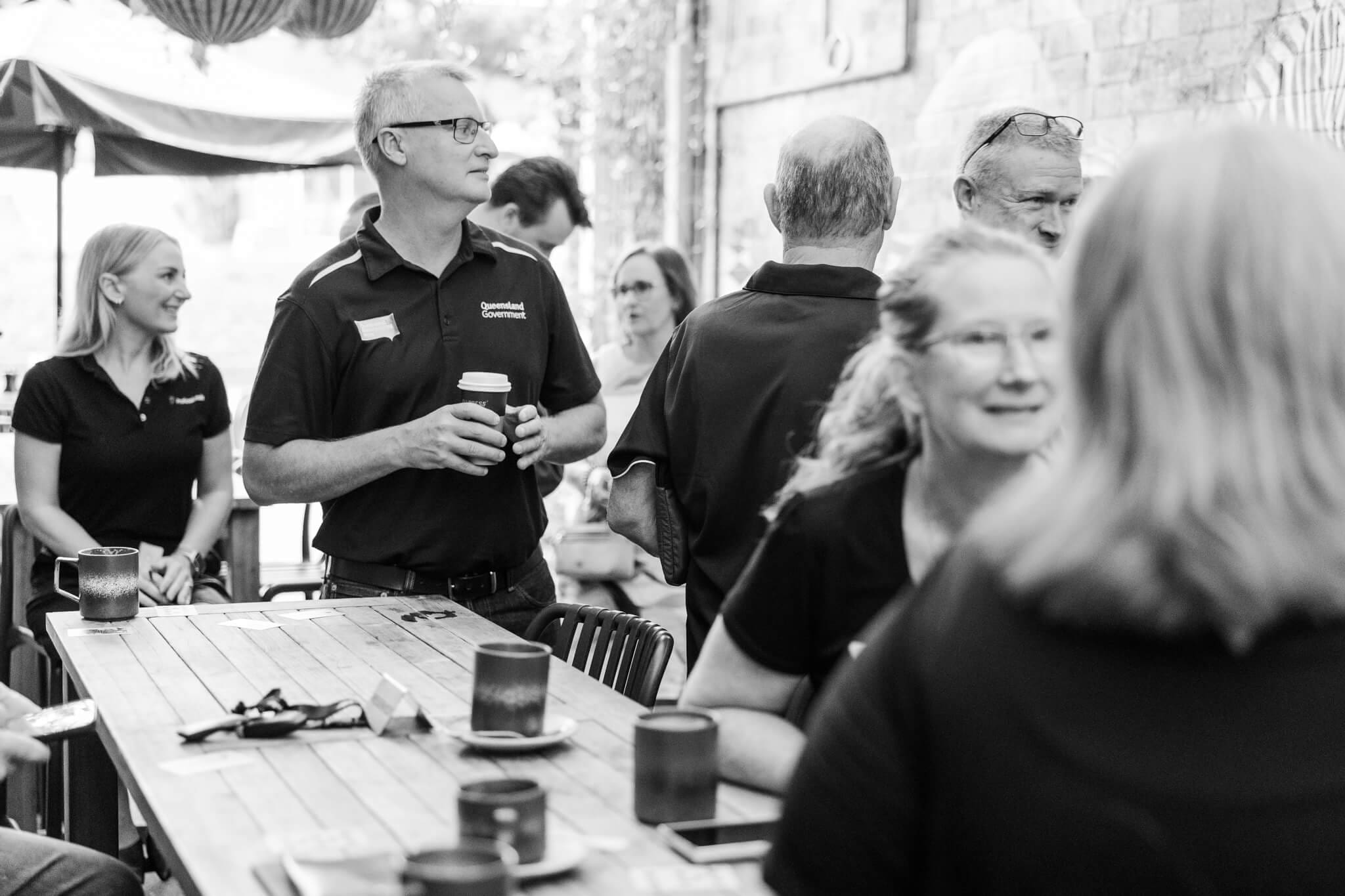 Business members meet to network at The Alley Yeppoon.  Black and white image of the event featuring some of the attendees.