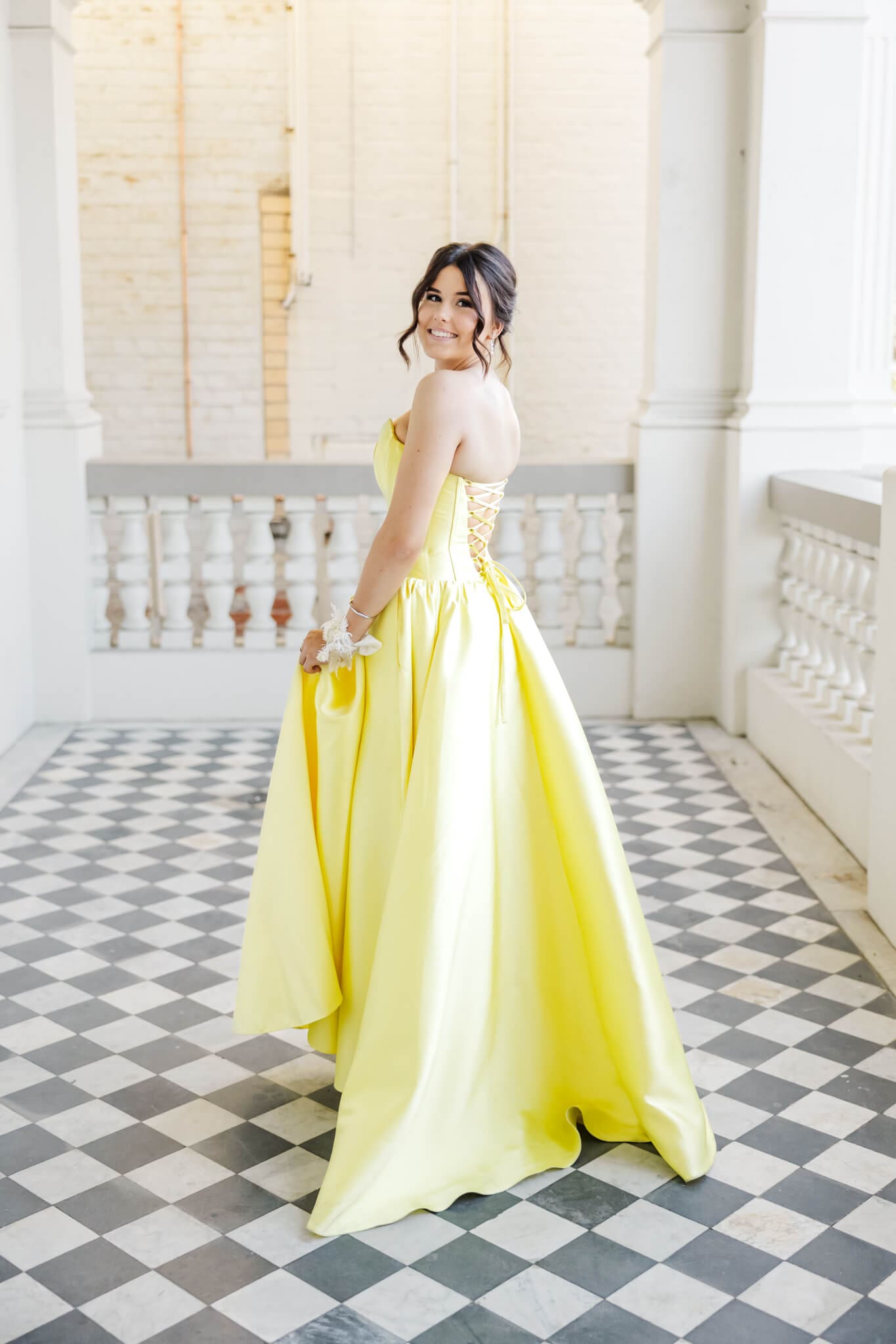 Formal graduate wears a stunning yellow dress that has had dress alterations in Rockhampton.