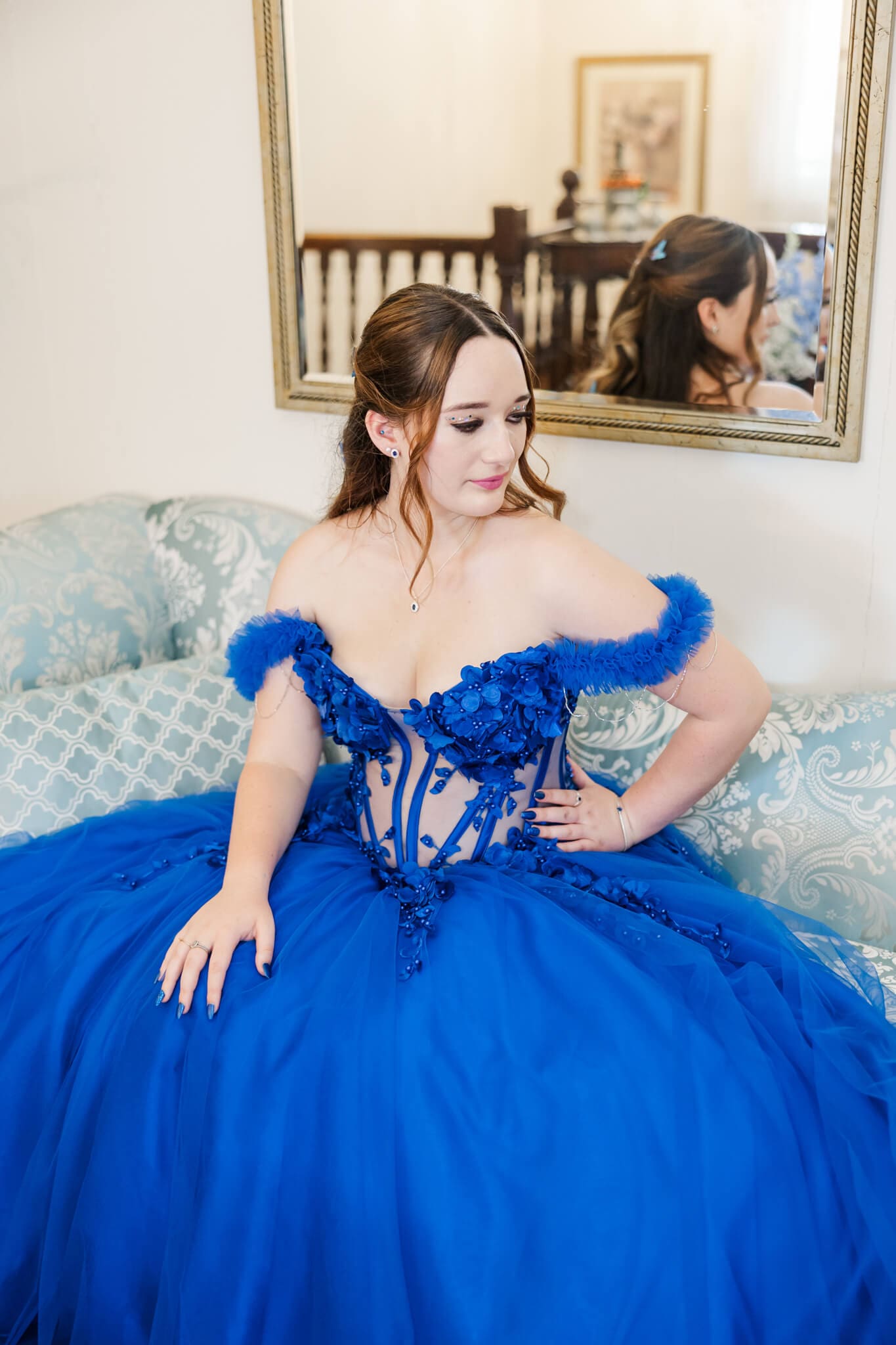 Formal graduate poses for her formal session an a gorgeous blue gown created by a woman who does dress alterations in Rockhampton.