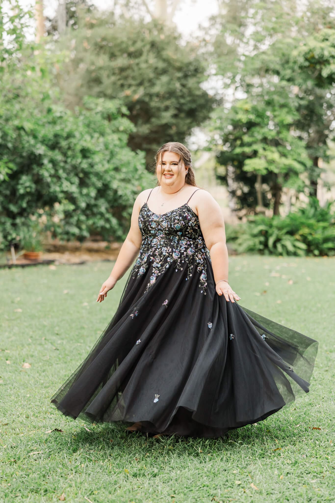 Formal Graduate spins in her black dress as she poses for her formal photos. Dress alterations in Rockhampton by Wendy Mylea.